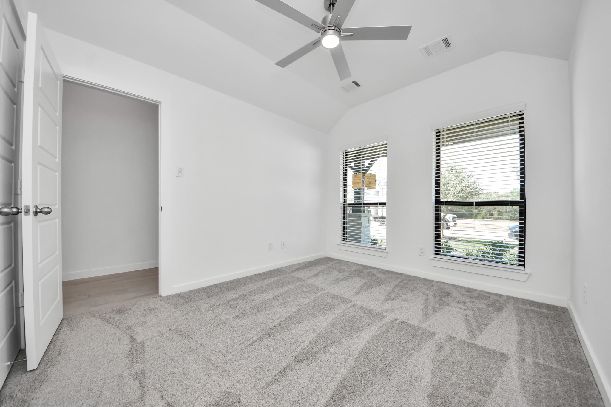 Generously sized secondary bedrooms featuring spacious closets, soft and inviting carpeting underfoot, large windows allowing plenty of natural light, and the added touch of privacy blinds for your personal retreat.