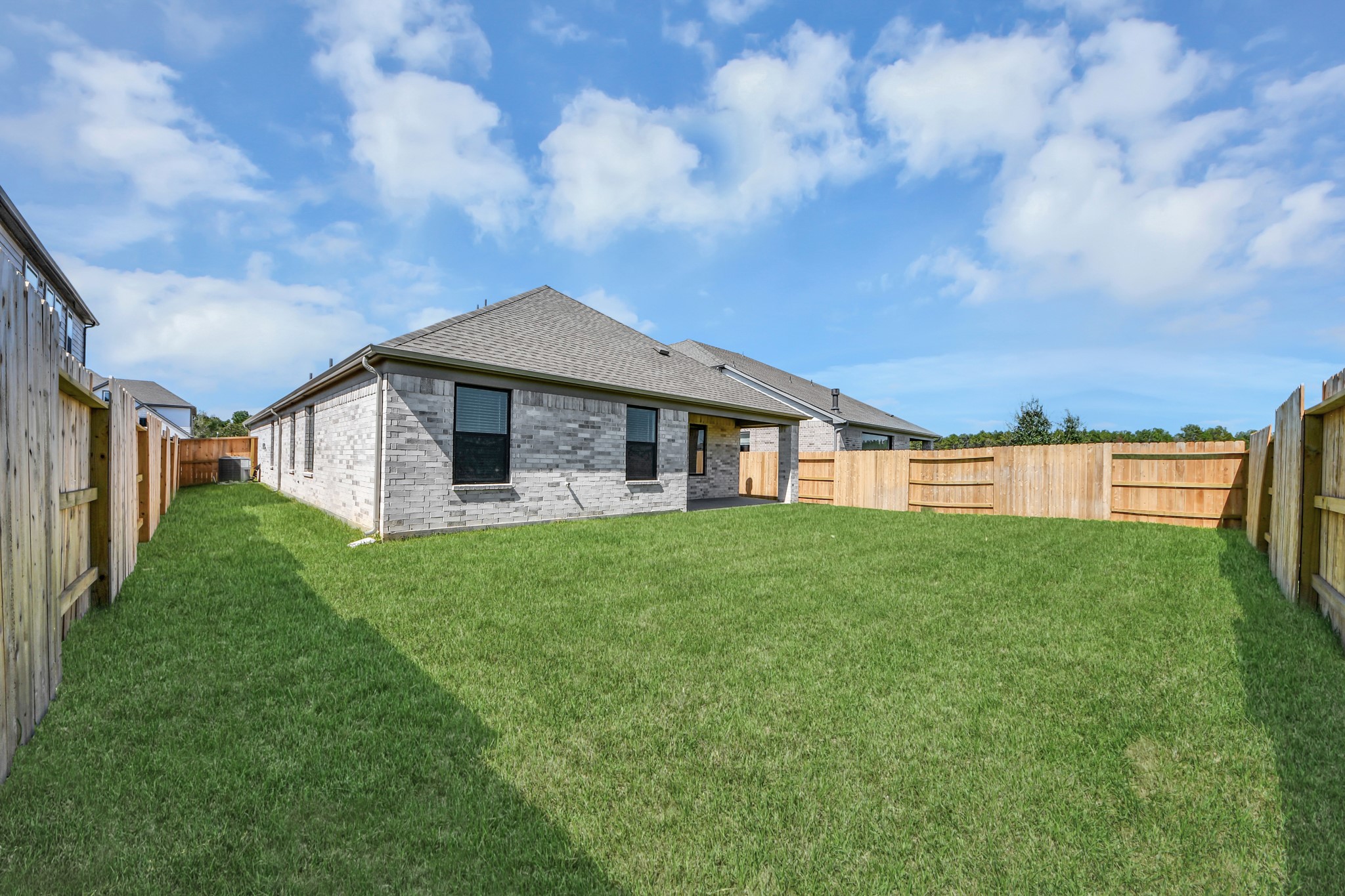 Experience outdoor living at its finest on this expansive covered patio, thoughtfully designed for BBQs and delightful outdoor dining.