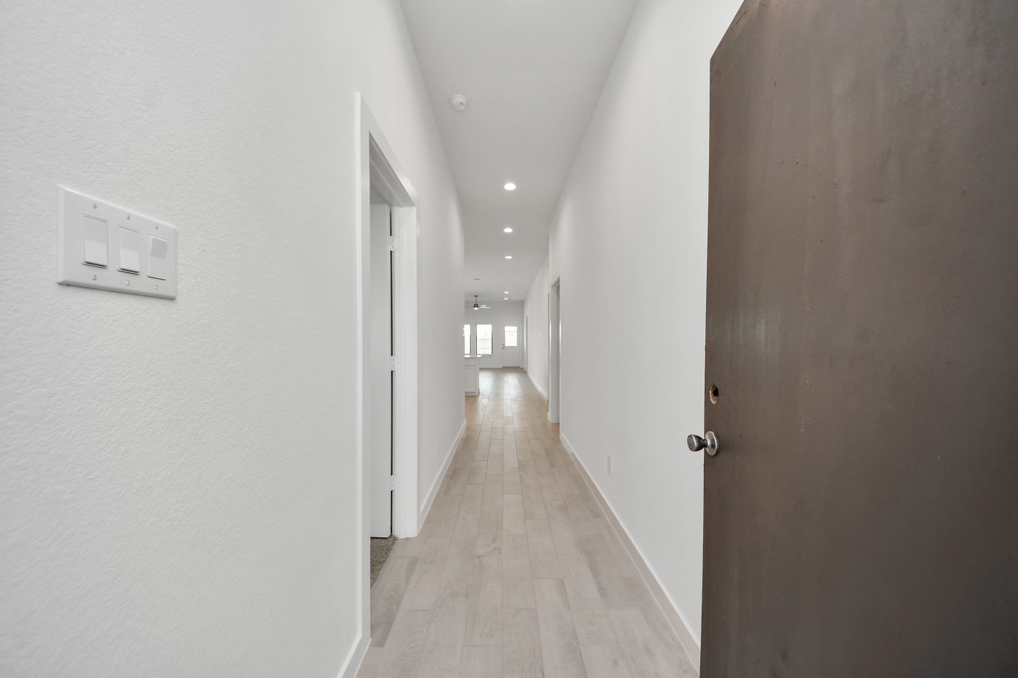 As you step into the threshold of this luxurious home, you'll soon be welcomed by an elegant glass door (to be installed). Inside, soaring ceilings amplify the spaciousness, while the refined wood-look tile flooring and oversized baseboards exude sophistication and charm.
