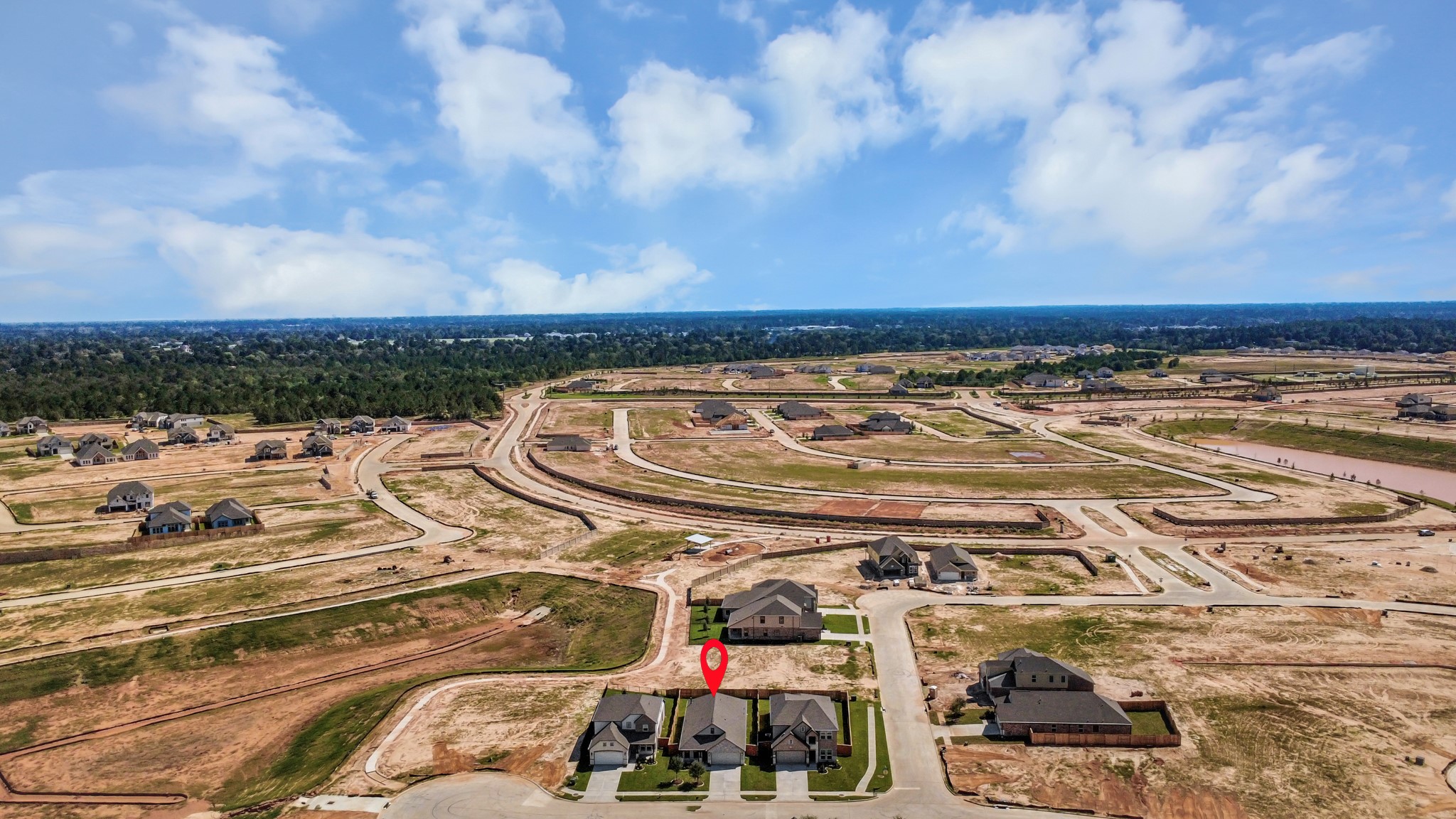 An aerial view of a spacious subdivision lot, highlighting a well-maintained yard and a fully fenced perimeter, offering both privacy and expansive outdoor space.