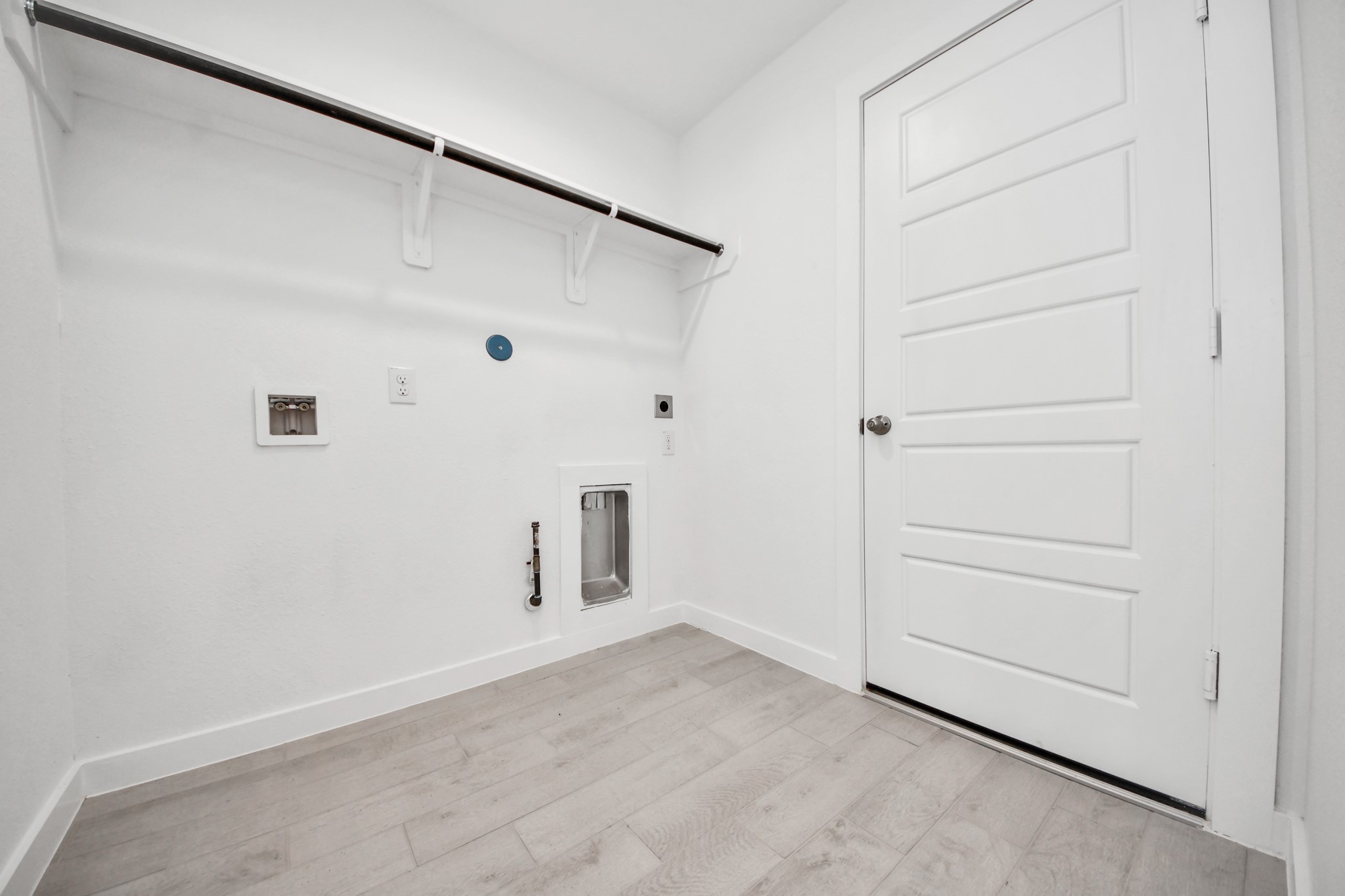 A perfect blend of functionality and comfort. Capture the essence of easy living with a first-floor laundry room, thoughtfully equipped with shelving for effortless organization. Both electric and gas connections available.
