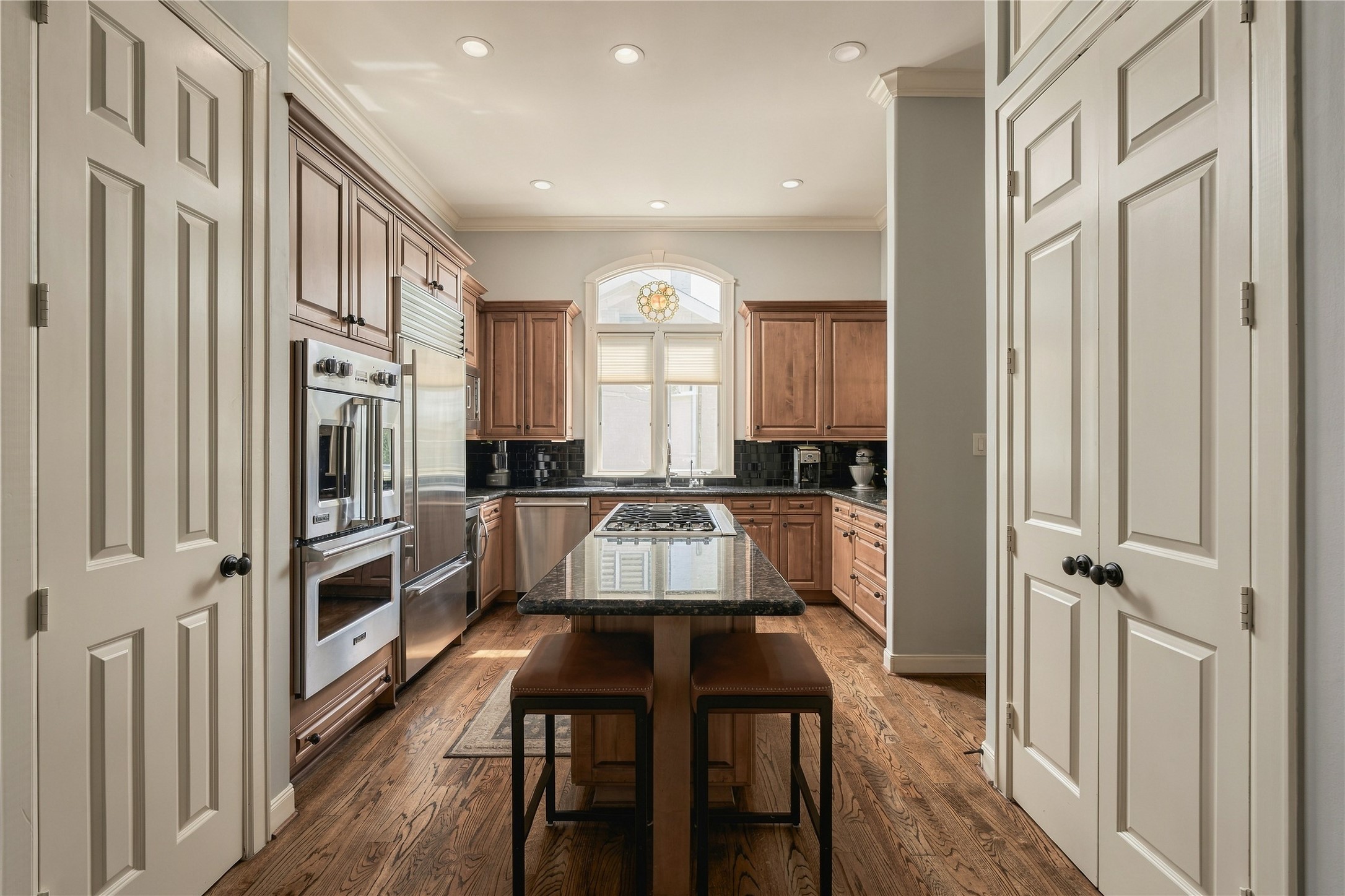 From this angle, the kitchens scale really comes into focus, with the long central island, extensive cabinetry and multiple storage areas keeping everything within reach.