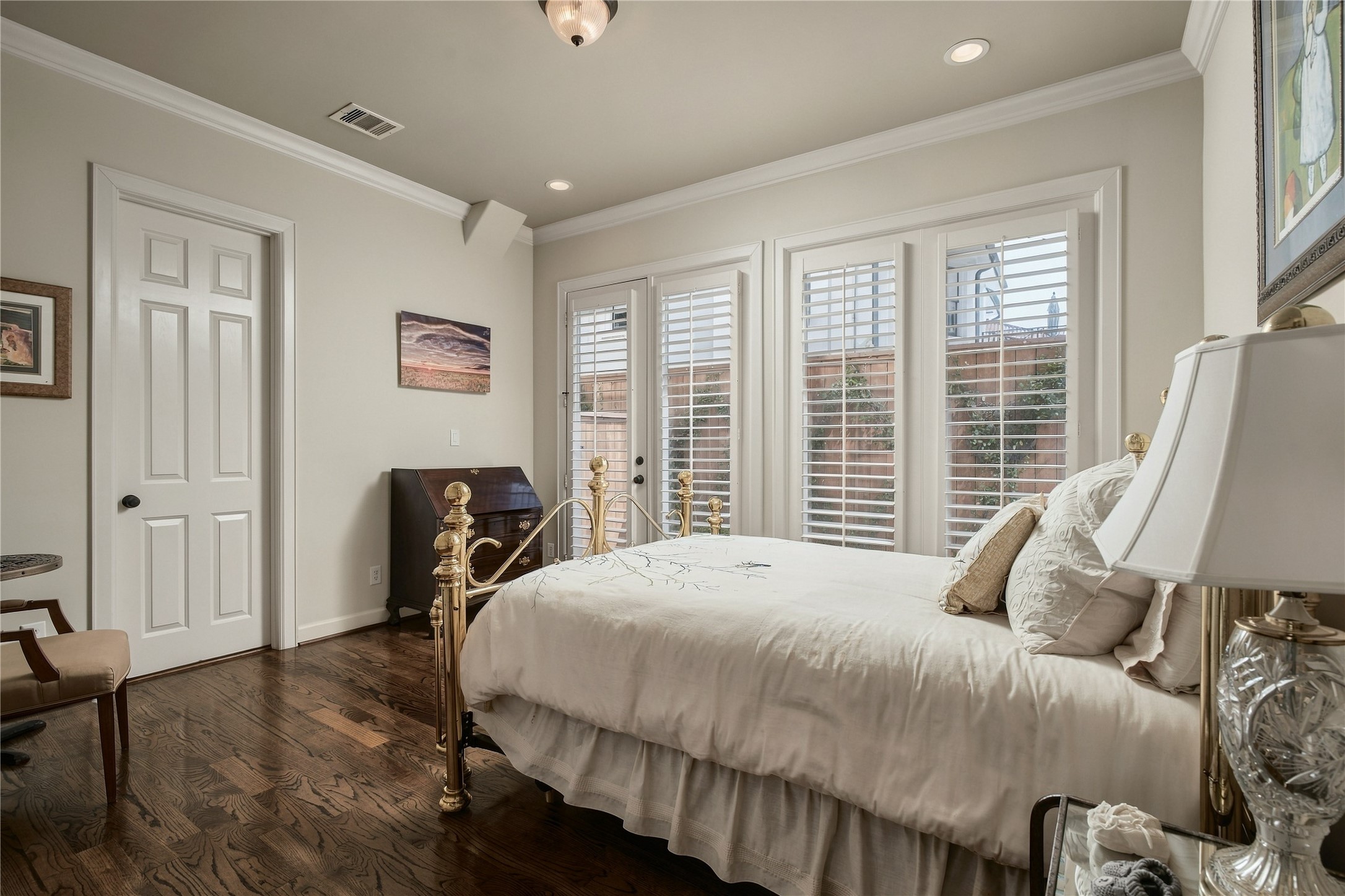 The second first-floor bedroom has a different feel entirely, with French doors bringing in natural light and creating an unexpected connection to the outdoors.