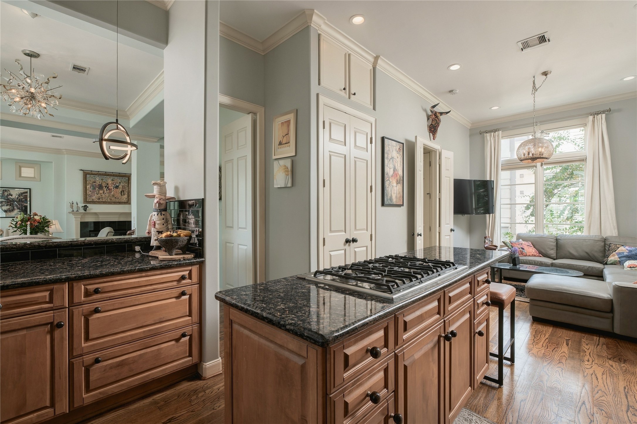 The kitchen opens into a more casual living space, creating an easy everyday counterpart to the more formal rooms at the front of the home.