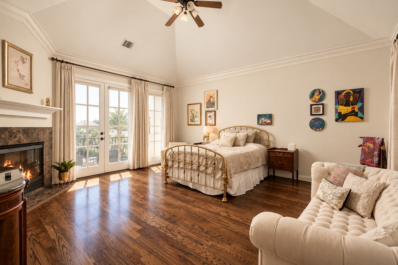 The primary suite feels almost like its own apartment, with a vaulted ceiling, fireplace, sitting area and French doors extending the room outdoors. **Rendering of neutral wall color**