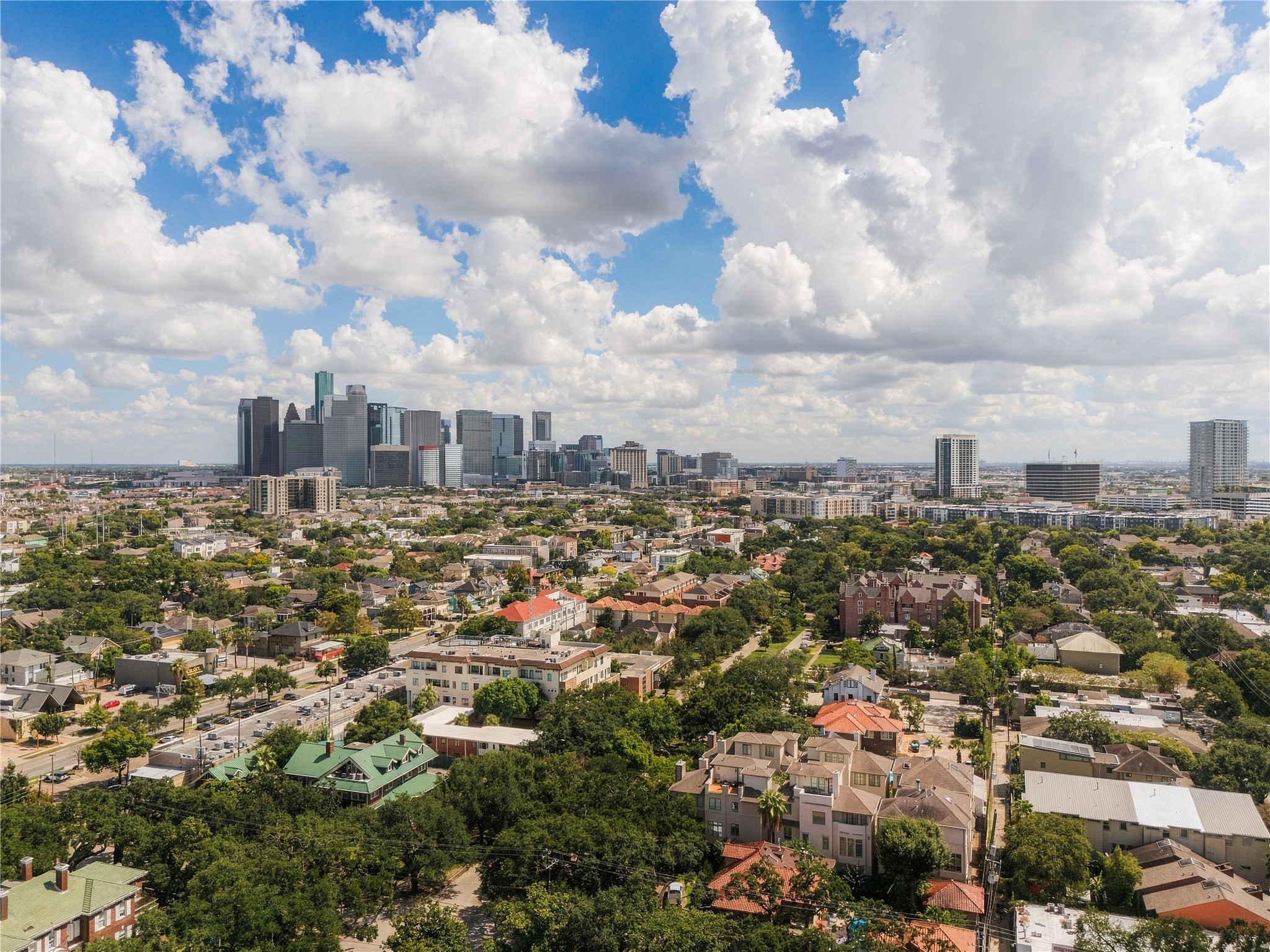 Another perspective captures the Downtown skyline rising above the surrounding Montrose neighborhood.