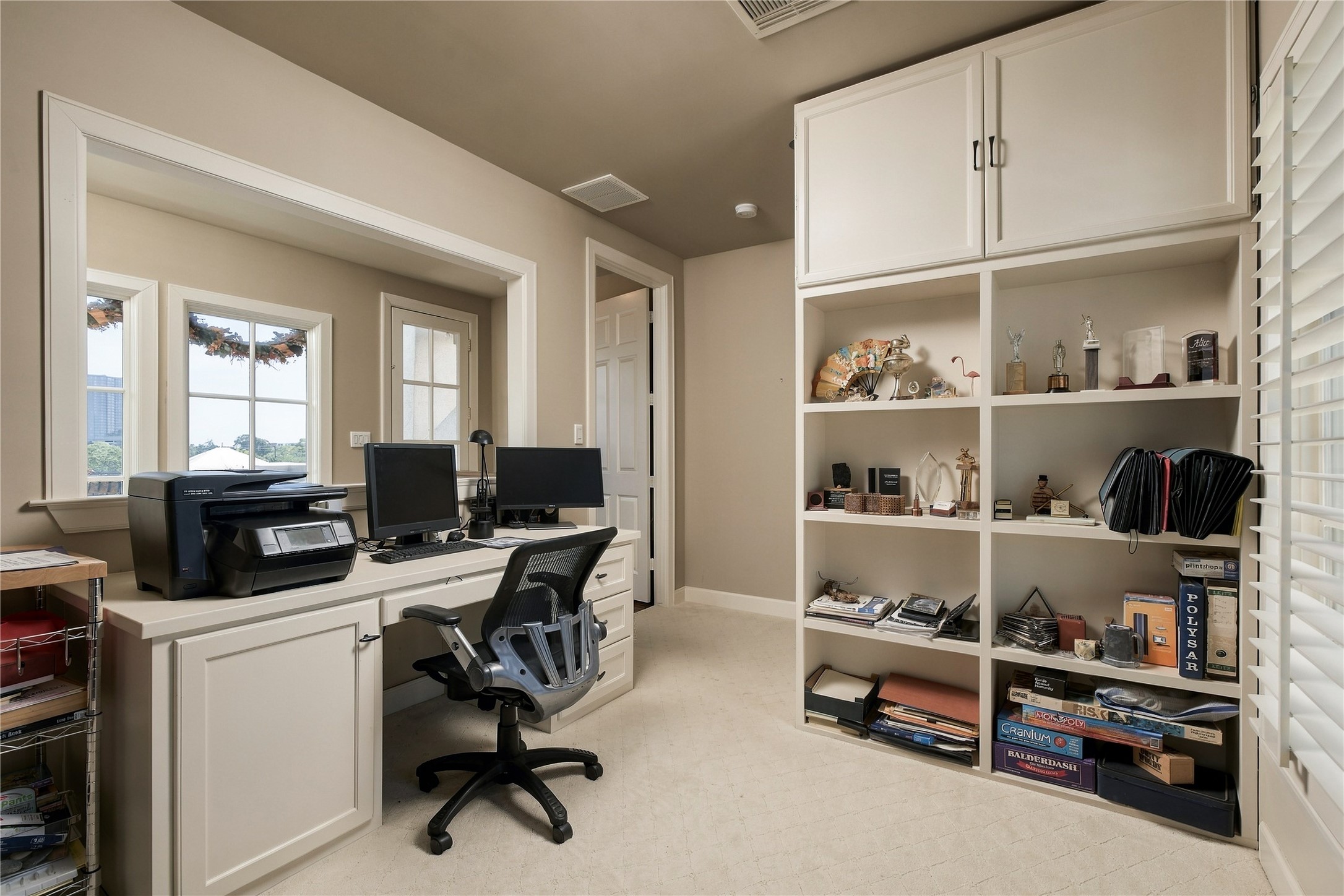 Finished fourth-floor bonus room offers a flexible space for a home office, media room or additional living area, complete with built-in cabinetry and shelving.