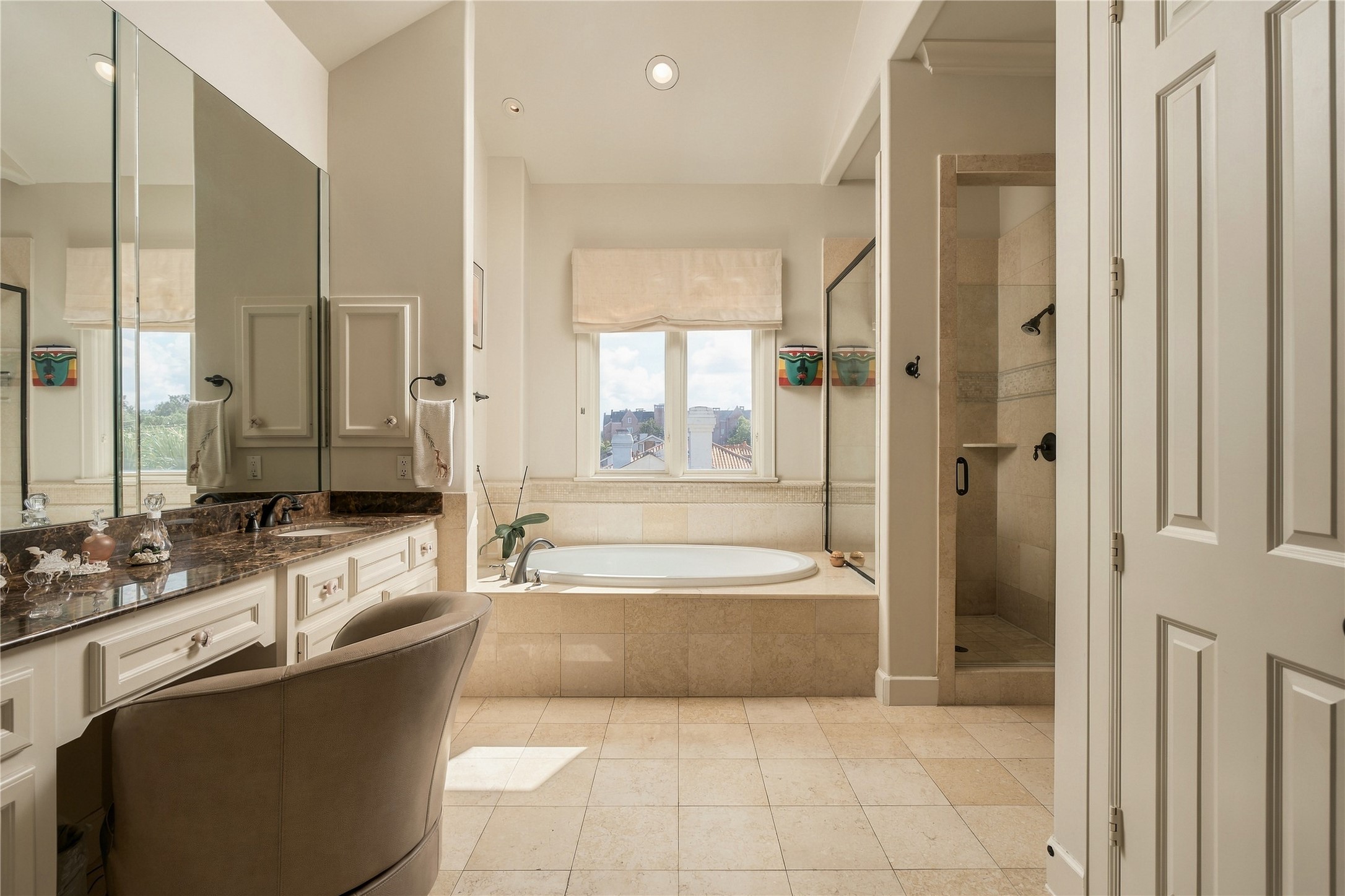 A wider view captures the scale of the primary bath and its separation of vanity, bathing and shower spaces.