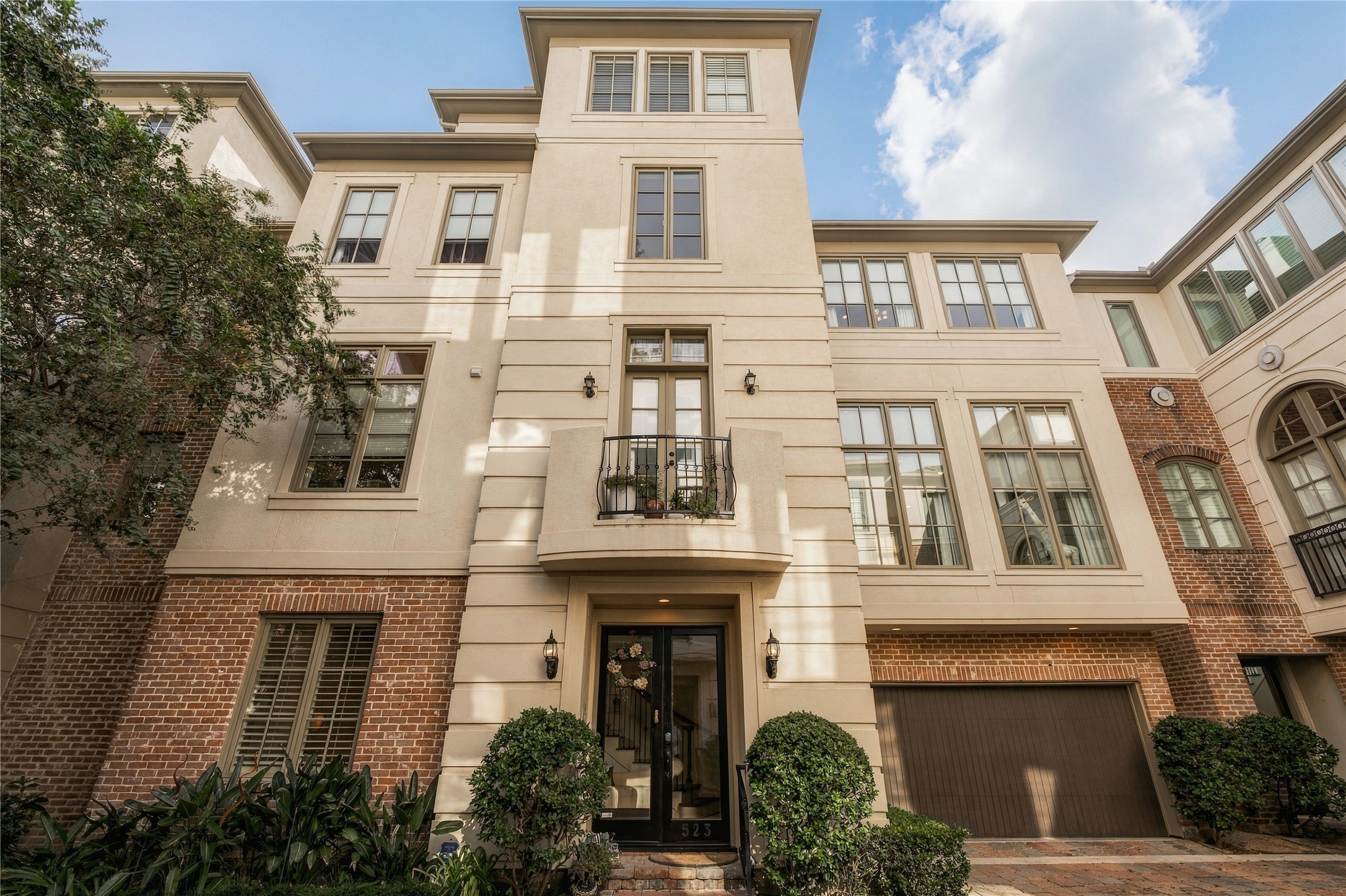 Set quietly within Lovett Gardens, 523 Lovett blends classic brick and stucco architecture with four levels of living in the middle of Montrose.
