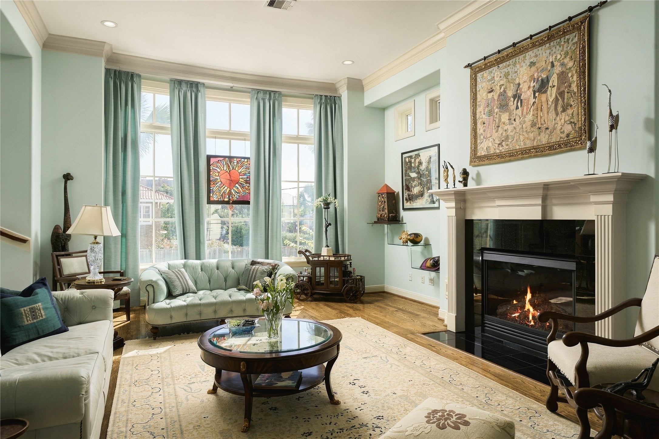 Natural light becomes part of the room itself, pouring through the expansive windows and shifting the feel of the space throughout the day.