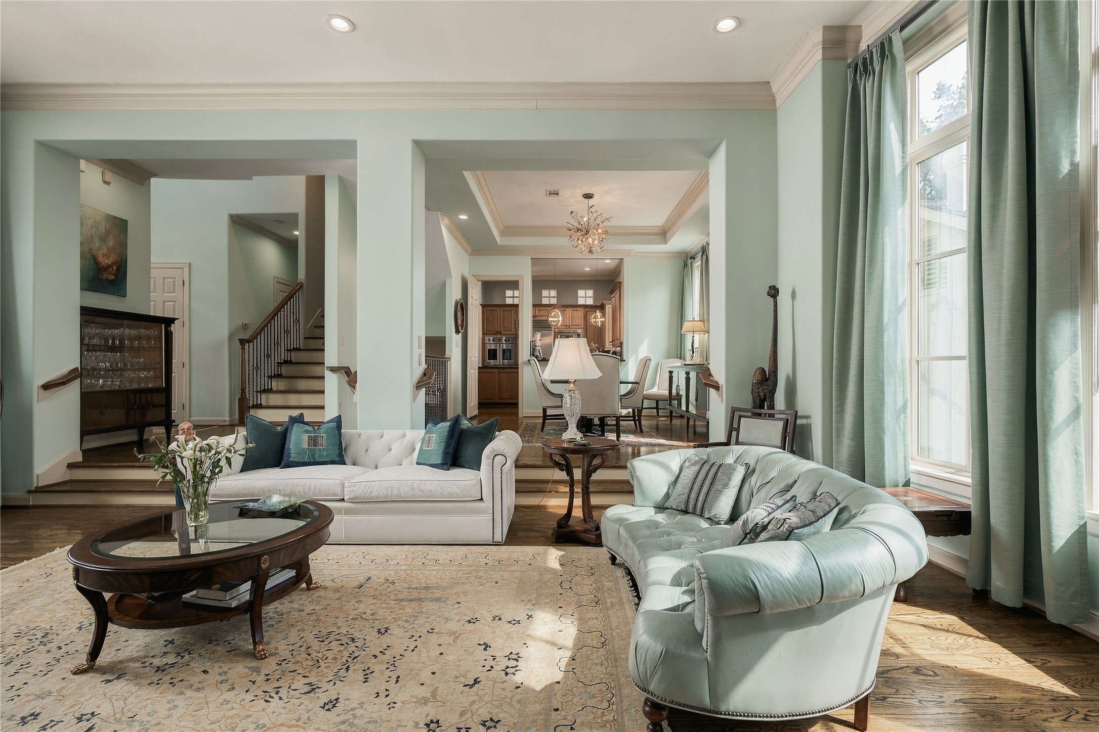 Open enough to stay connected, but not so open that every room loses its identity. The subtle change in elevation gives dining and kitchen their own sense of place.