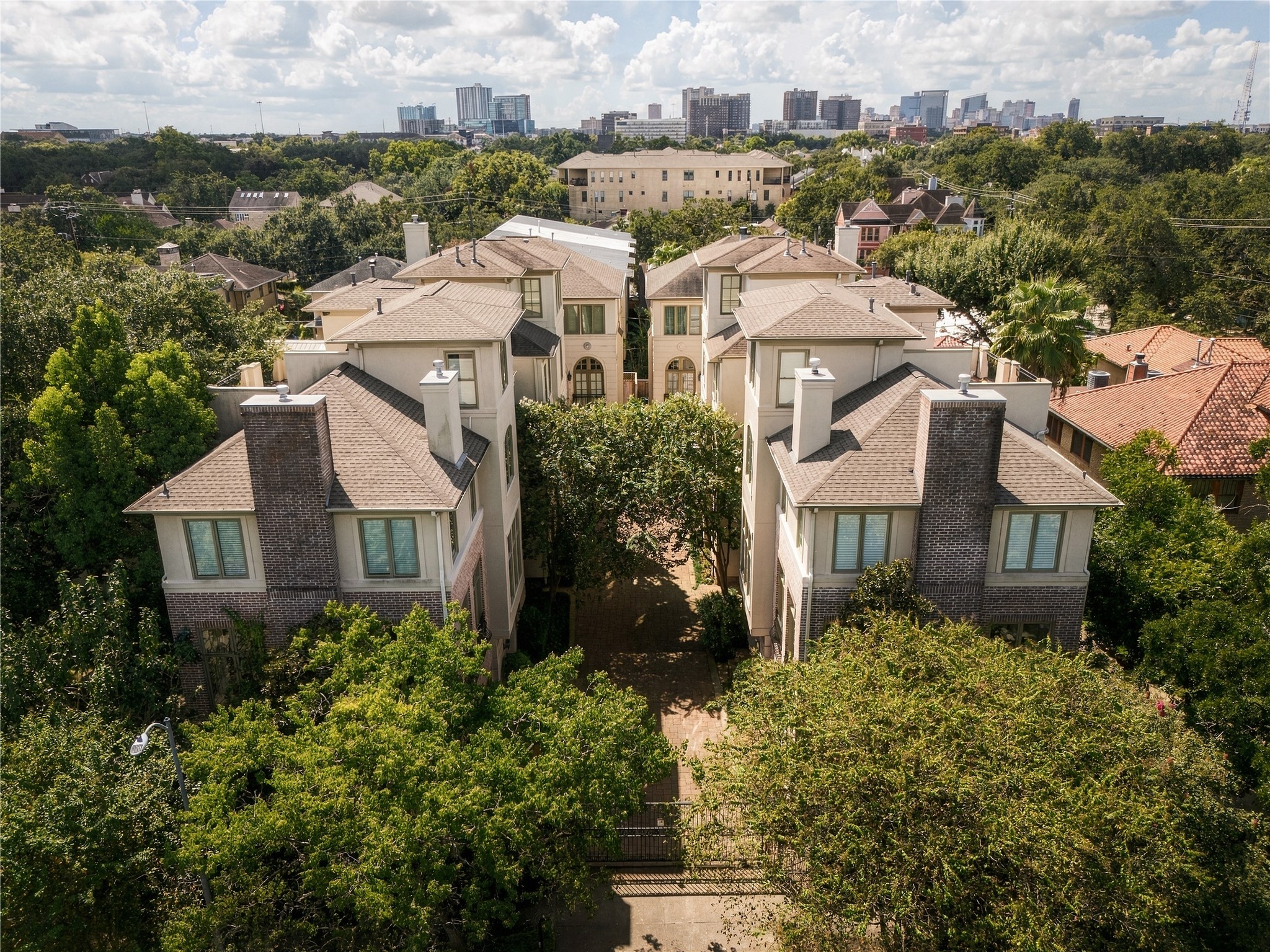Aerial view of the gated Lovett Gardens community, tucked into the surrounding Montrose neighborhood with the city beyond.