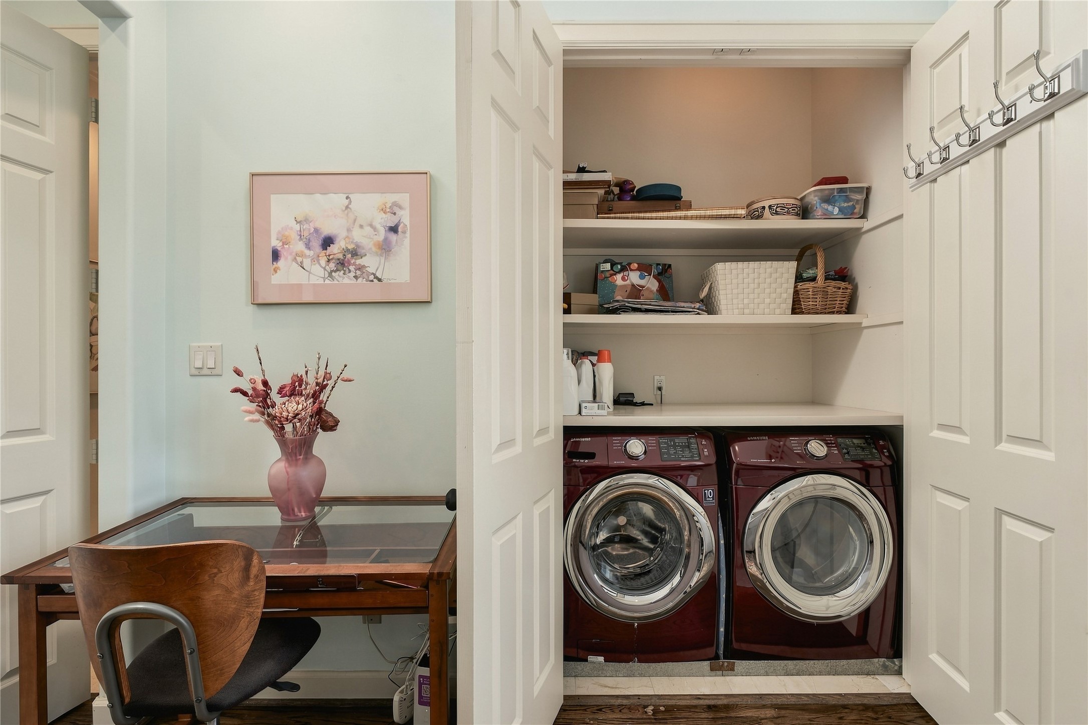 The primary suite includes a dedicated laundry area positioned just steps from the bedroom and bath, adding everyday convenience without sacrificing the adjoining flex space.
