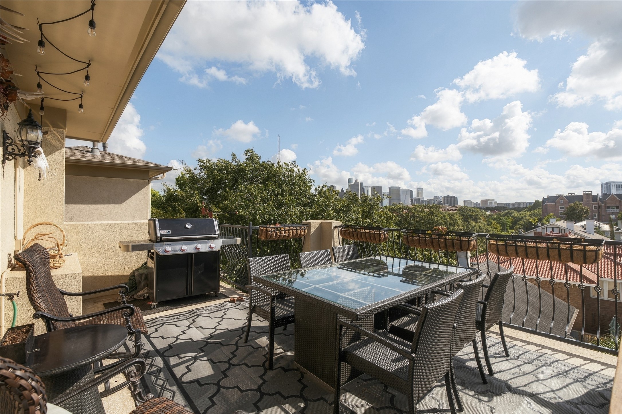 The fourth-floor terrace creates an incredible outdoor entertaining space with room for dining and grilling, all overlooking the Downtown Houston skyline.