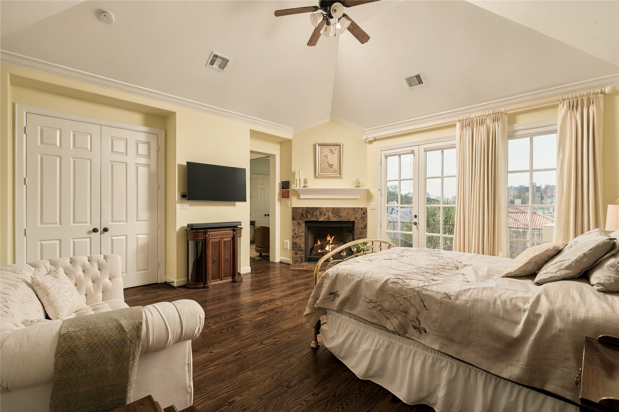 This is a bedroom designed for lingering, with morning light through the French doors, a fireplace for cozy evenings and enough room to create a true sitting area away from the rest of the home.