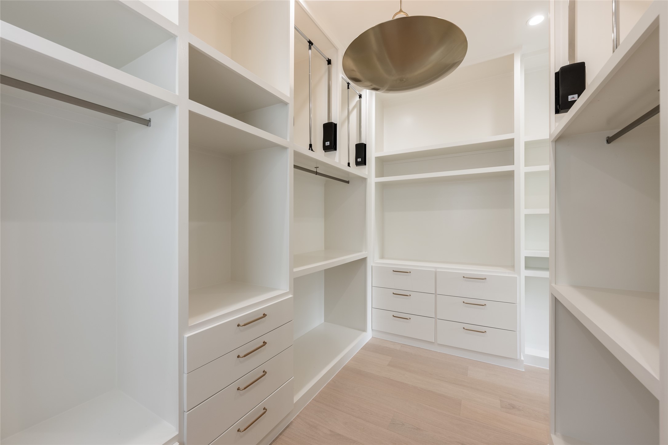 The expansive primary closet is thoughtfully outfitted with custom built ins, dedicated drawers and abundant hanging space, creating a dressing room experience designed around organization.