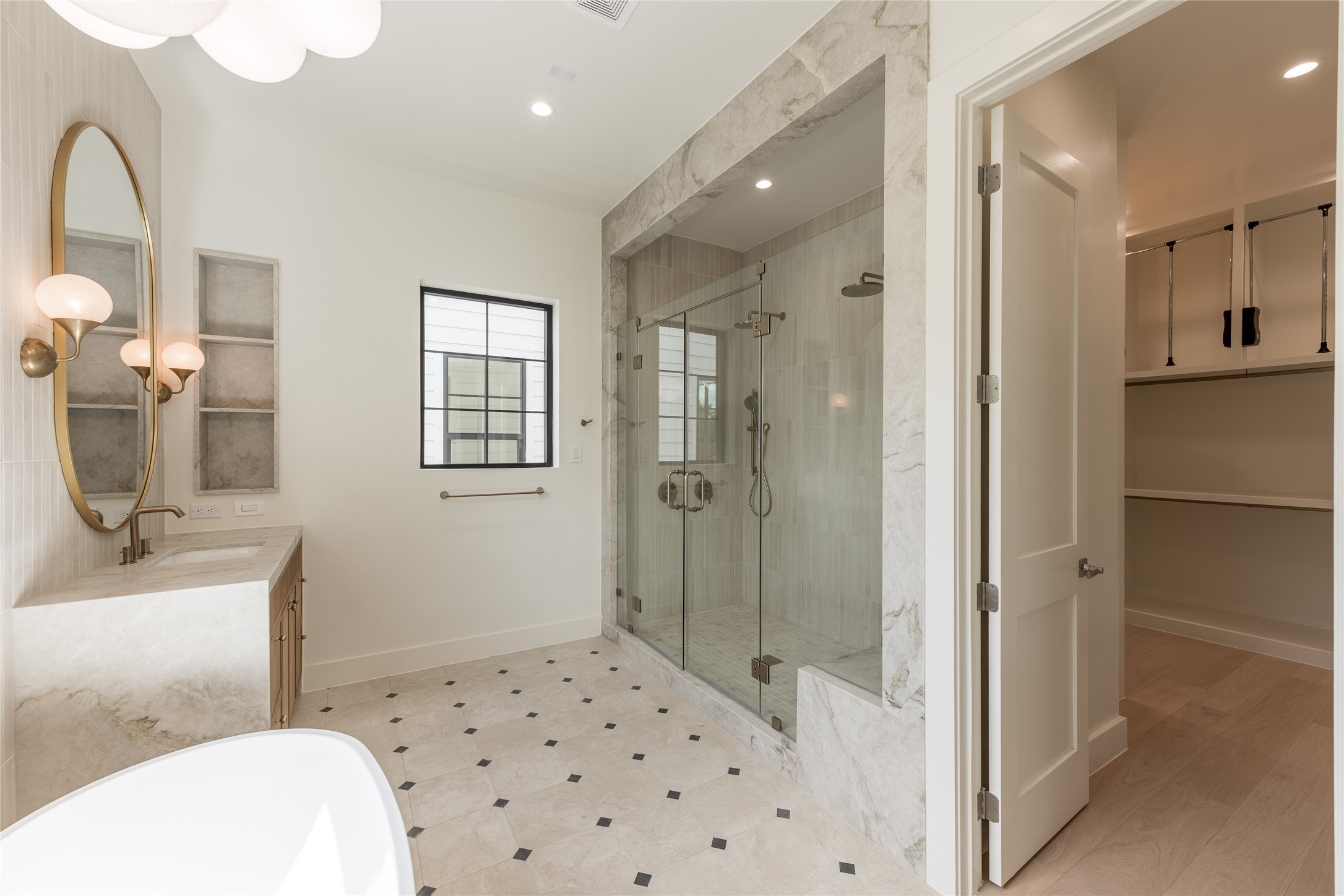 A seamless transition from the primary bath leads into the generous walk in closet, with custom built in shelving extending the suites thoughtful design into everyday function.