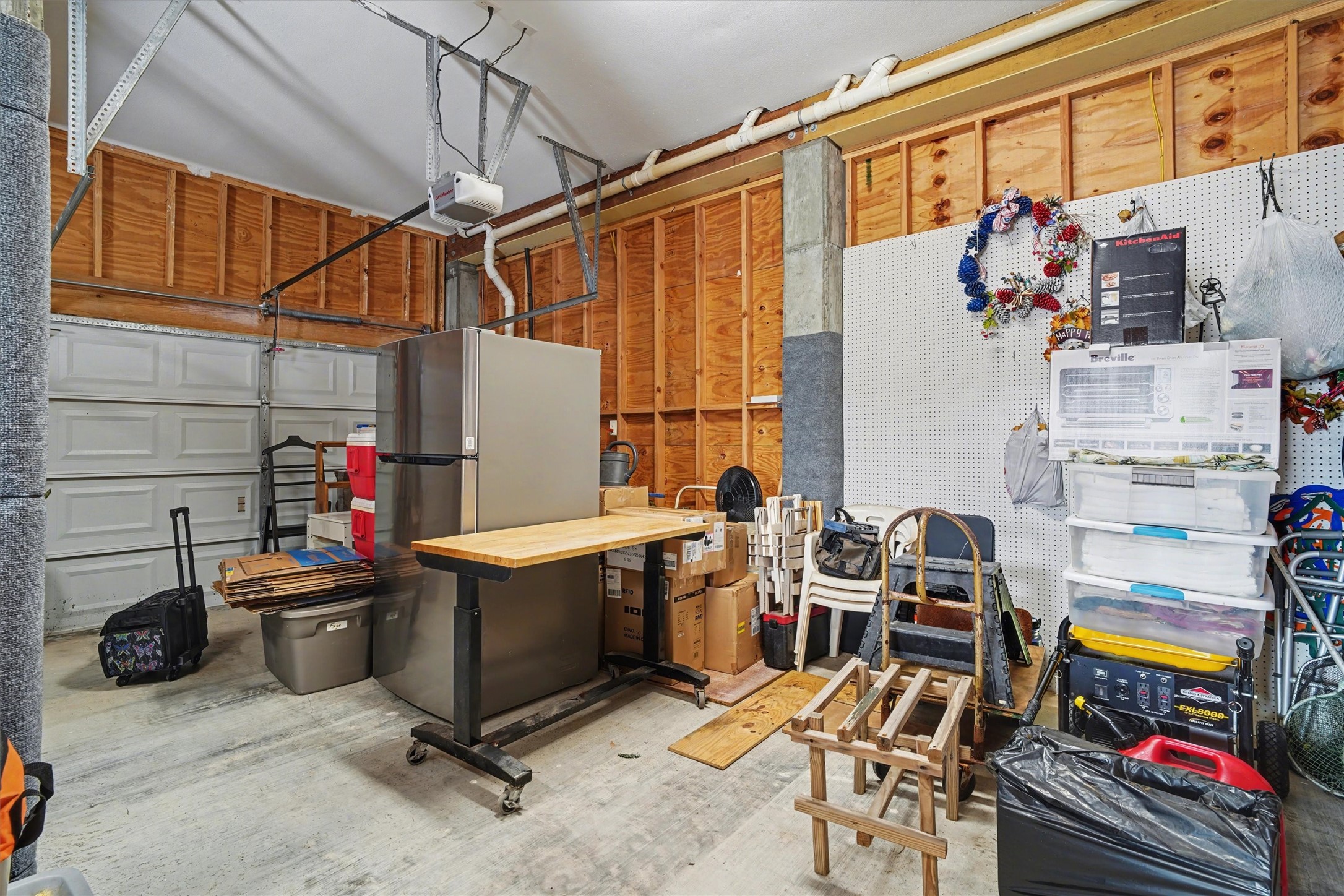 Oversized double garages offering exceptional space for vehicles, a golf cart, boat trailer, or additional storage. Thoughtfully designed for convenience and versatility, this area provides ample room to organize, protect, and enjoy all the essentials of waterfront living