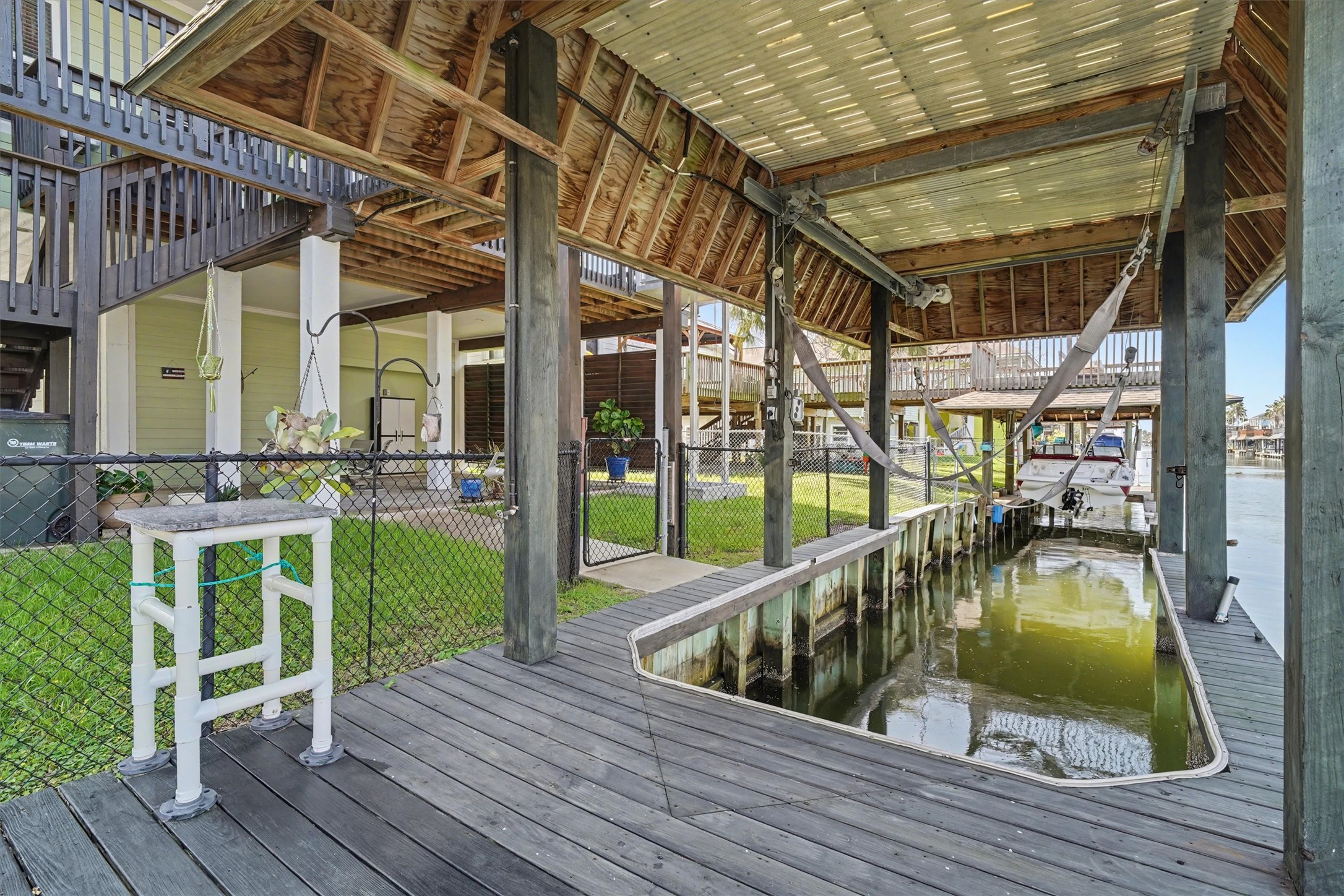 Waterfront paradise with a private boat slip and spacious dockperfect for fishing, crabbing, swimming, or simply relaxing by the water. Thoughtfully designed with a convenient fish cleaning station and secure fencing along the waters edge, offering peace of mind for kids and pups alike