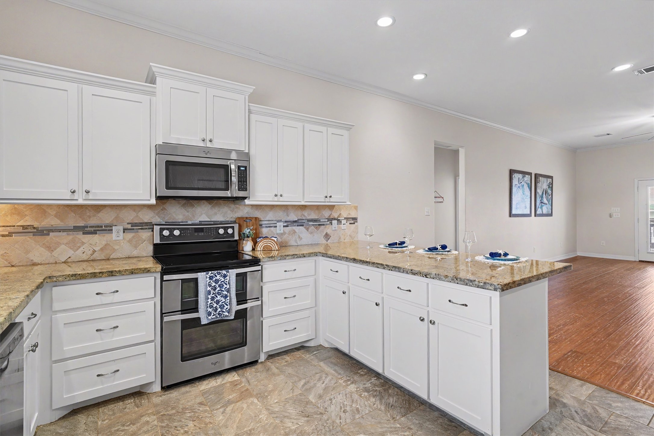 The kitchen's vastness ensures that multiple cooks can work harmoniously, creating a dynamic and inviting atmosphere for culinary creativity. Boasting an open concept layout, it seamlessly connects to the dining and living areas, making it perfect for entertaining and family gatherings