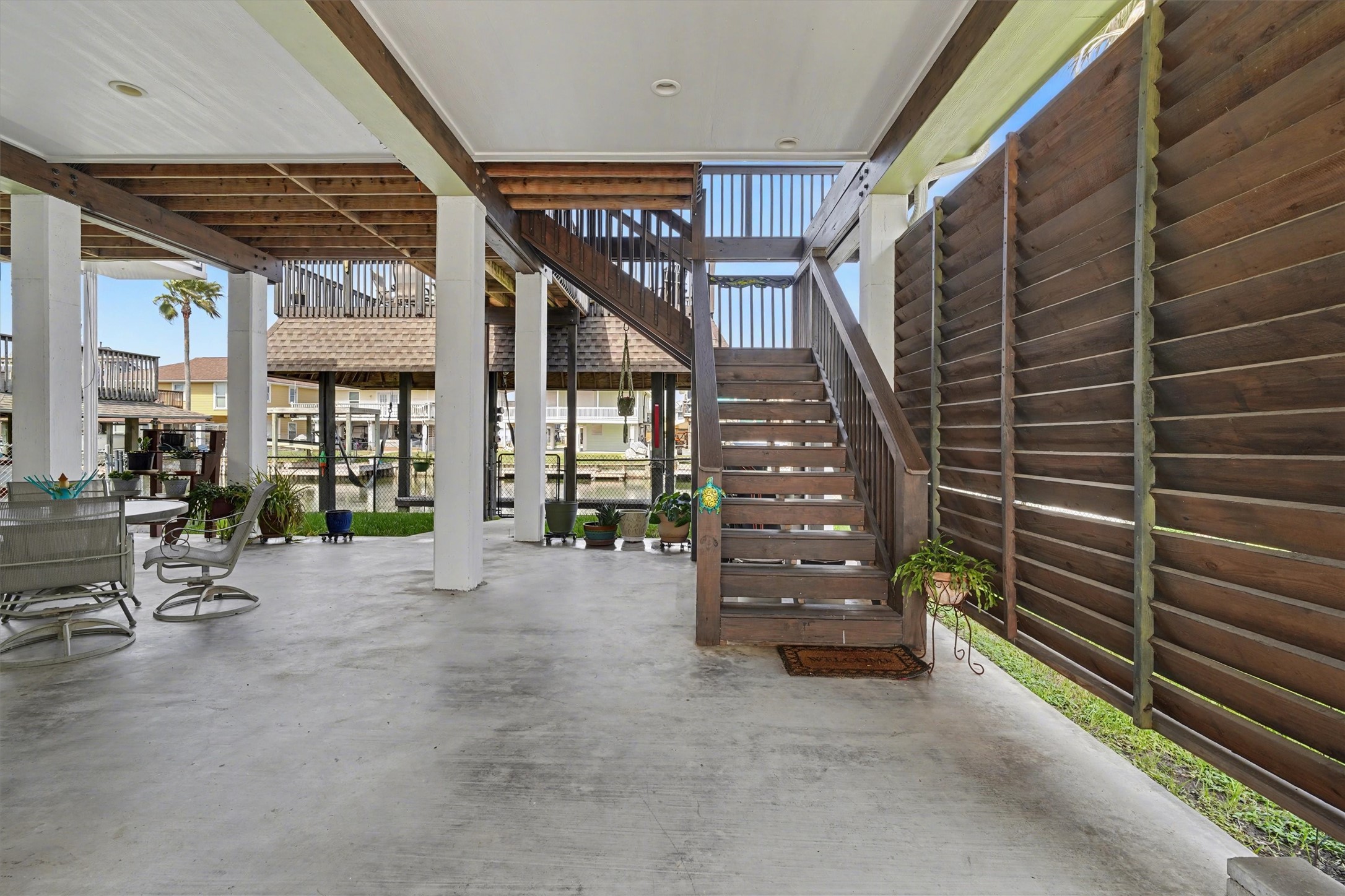 Inviting downstairs entertaining area designed for relaxation and gatherings, offering plenty of space for your favorite outdoor furniture. Enjoy the perfect blend of privacy and comfort with stylish side slats that create a cozy retreat while letting in the gentle coastal breezean ideal spot for unwinding or hosting under the open sky Inviting downstairs entertaining area designed for relaxation and gatherings, offering plenty of space for your favorite outdoor furniture. Enjoy the perfect blend of privacy and comfort with stylish side slats that create a cozy retreat while letting in the gentle coastal breezean ideal spot for unwinding or hosting under the open sky