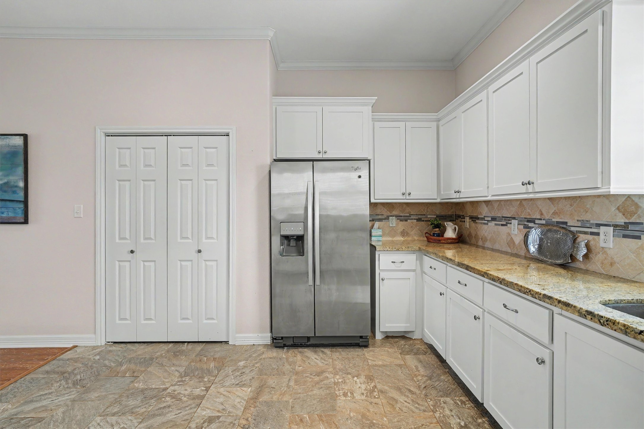 The refrigerator, a generous inclusion, stays with the home, ensuring you're ready to store your fresh ingredients from day one. Behind the doors, discover an impressively large pantry, providing ample space for all your kitchen essentials and more. With such thoughtful features, this kitchen truly caters to both the everyday chef and the gourmet enthusiast alike