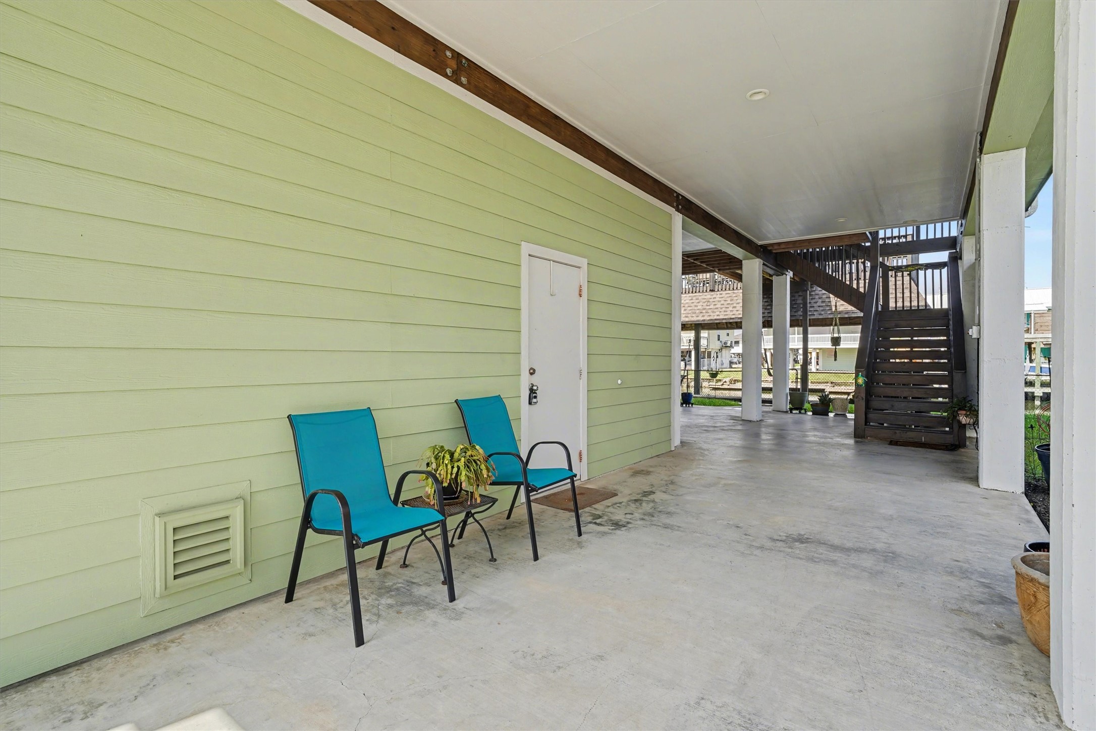 Downstairs open bay offering endless versatilitykeep it open for breezy waterfront enjoyment, use it for additional parking, or furnish it for extra outdoor living space. The ideal spot to park a golf cart and embrace the relaxed coastal lifestyle