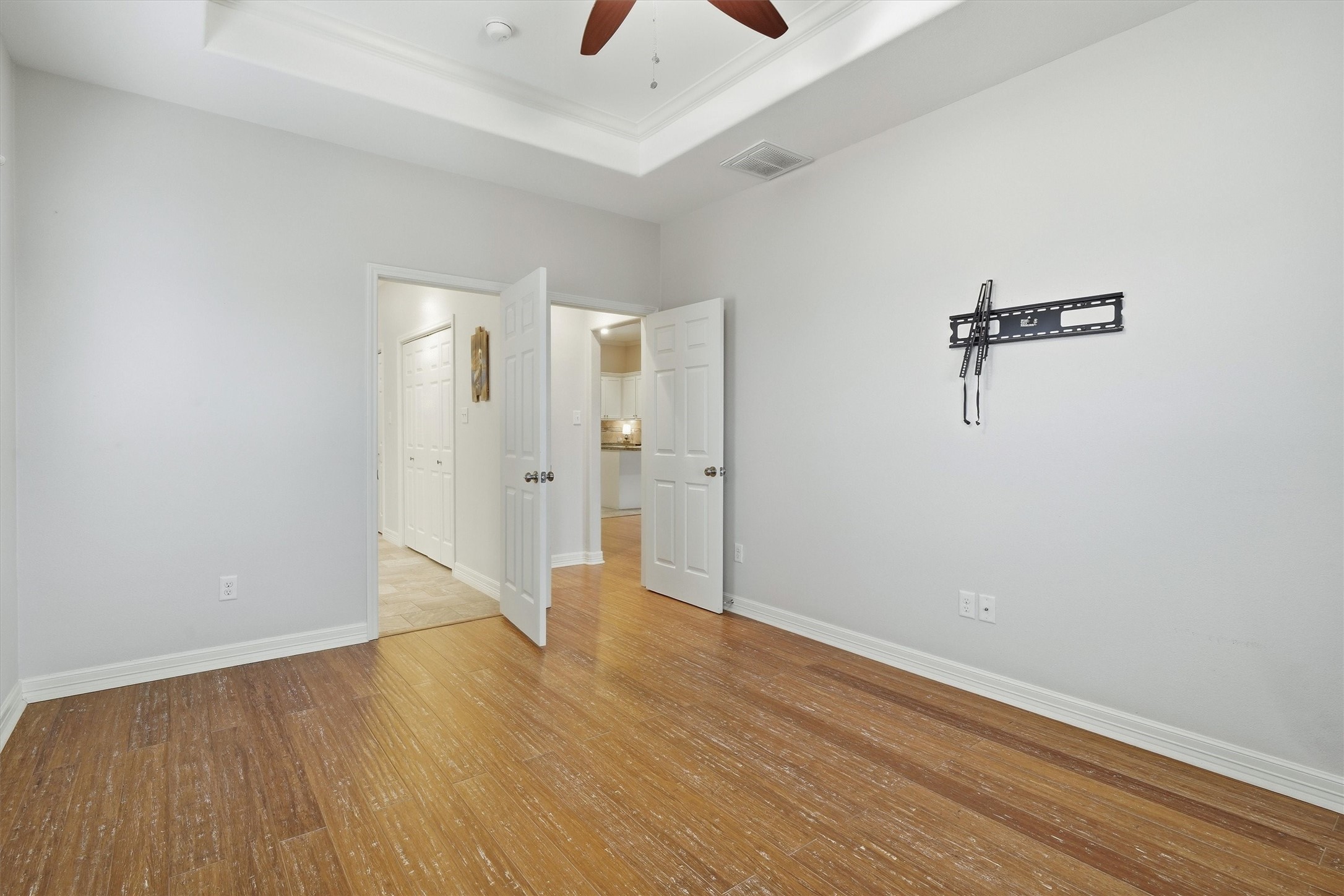 The TV wall mount is already in the primary bedroom. Notice the extra touch of the trayed ceiling.