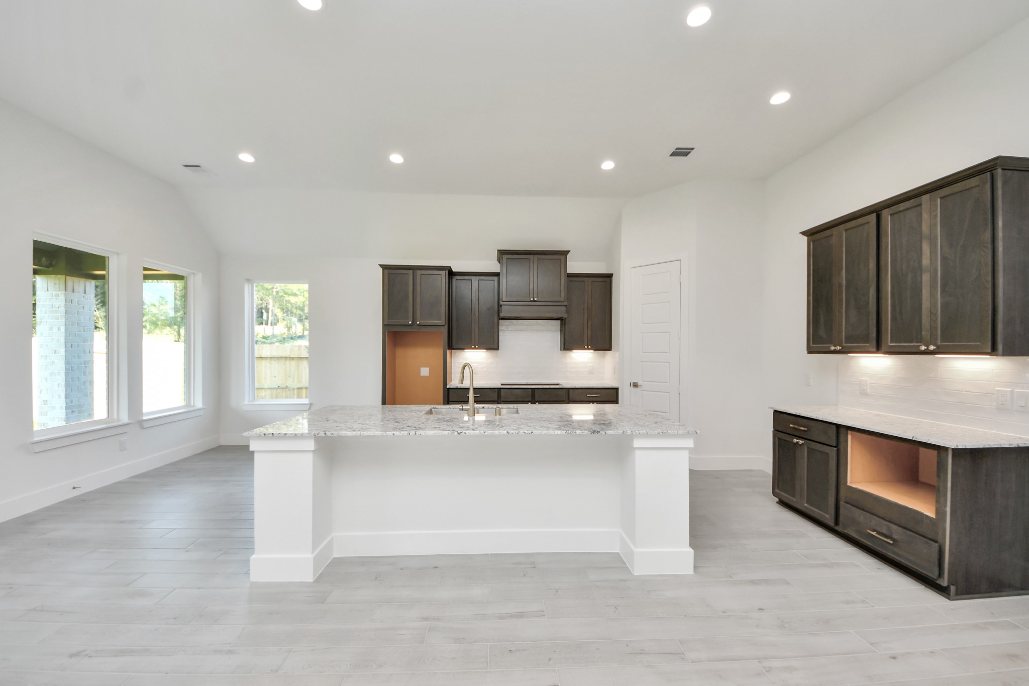All of this overlooks your expansive family room, creating a perfect space for culinary delights and family gatherings.
