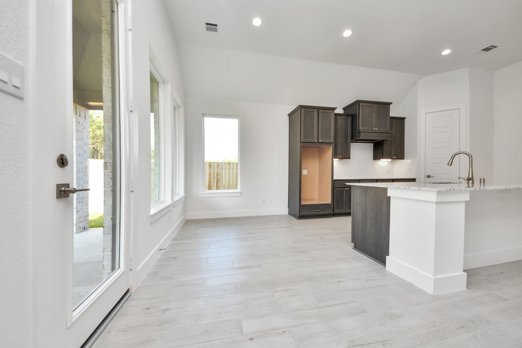 Enjoy breakfast with ease in the connected and cozy breakfast area, seamlessly integrated with the kitchen for utmost convenience. Step through the back door for a breath of fresh air onto the covered patio, extending your living space to the outdoors