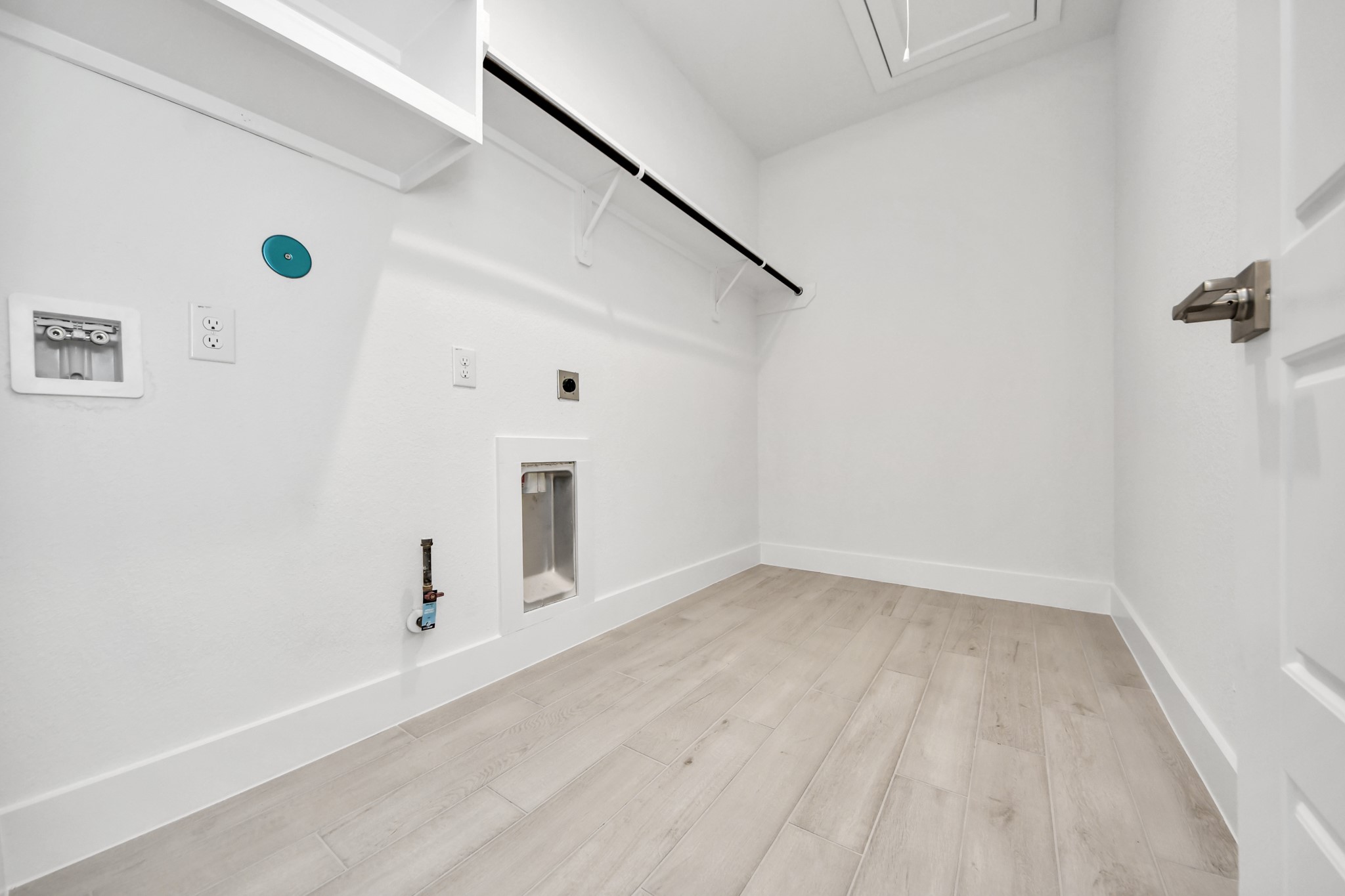 A perfect blend of functionality and comfort. Capture the essence of easy living with a first-floor laundry room, thoughtfully equipped with shelving for effortless organization. Both electric and gas connections available.