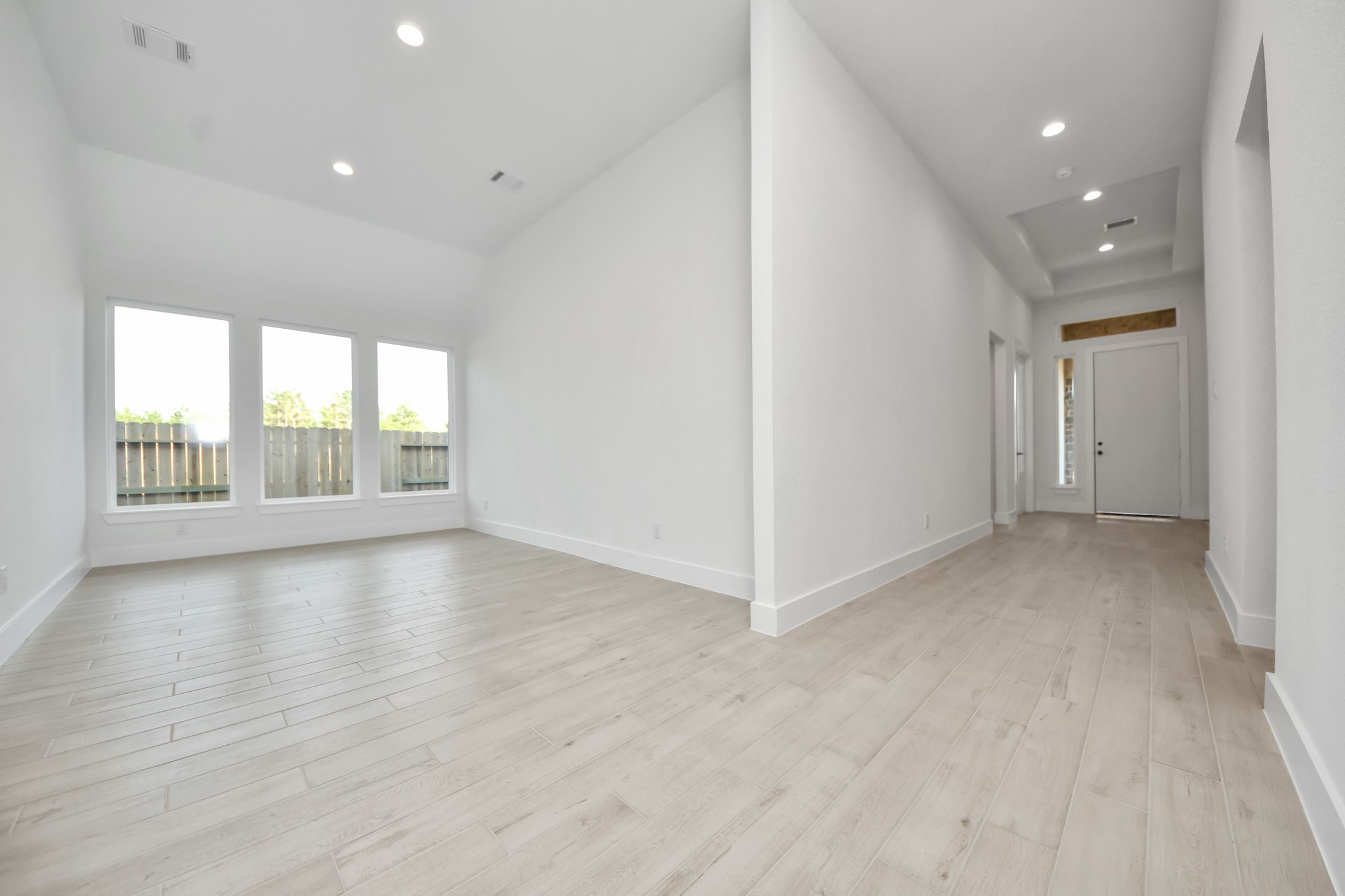 Create lasting memories with your family and friends at the dining table! This expansive dining room showcases sophisticated flooring, custom paint, and seamlessly connects to the family room and kitchen, providing an open and inviting atmosphere