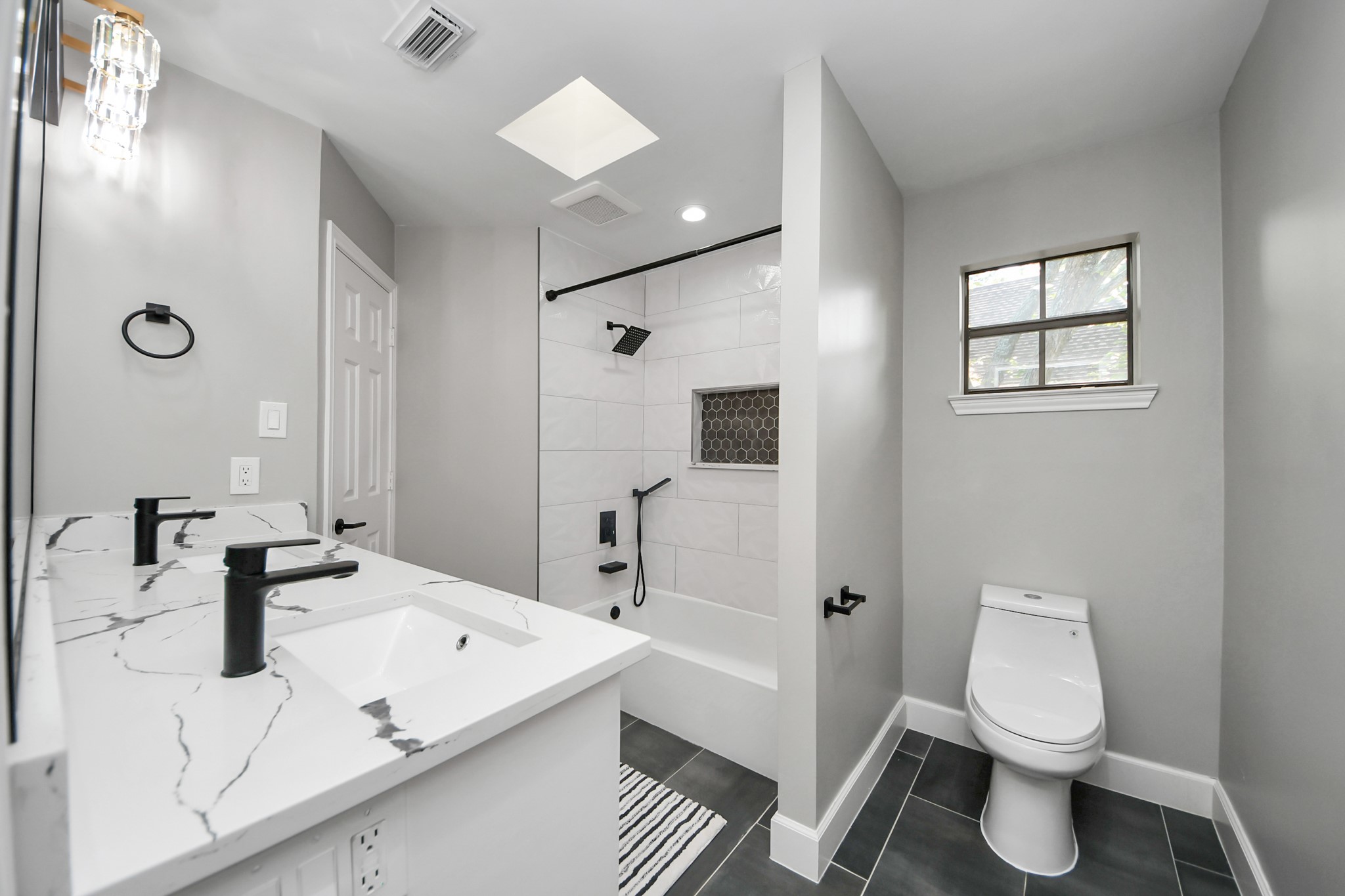 Great-sized secondary bathroom with ample storage.