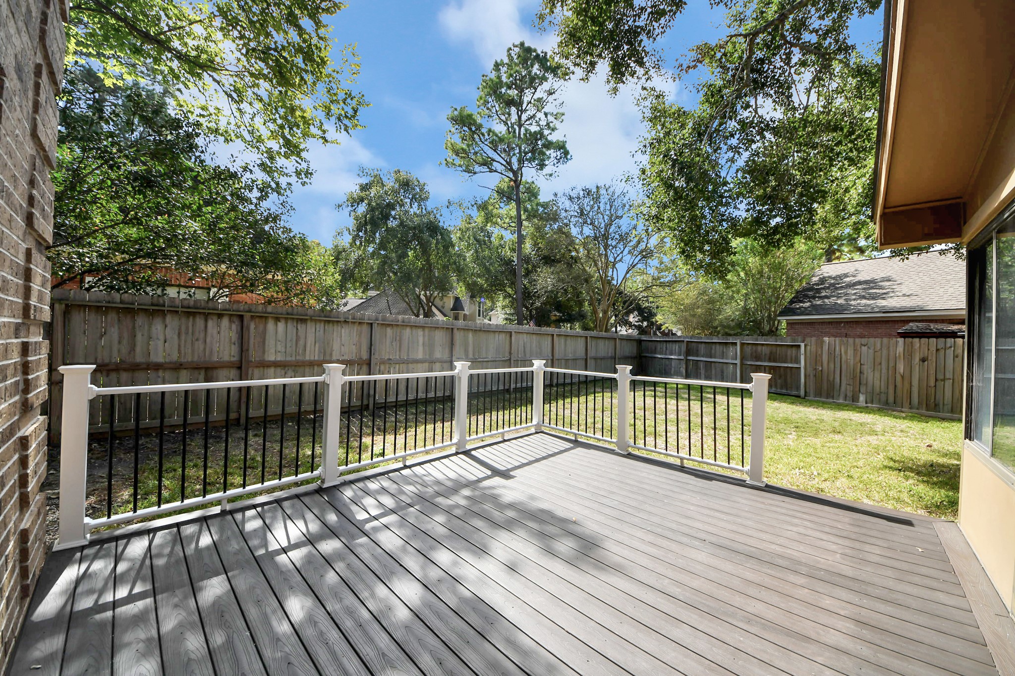 Backyard deck off the sunroom, perfect for outdoor relaxation, gathering, and grilling,