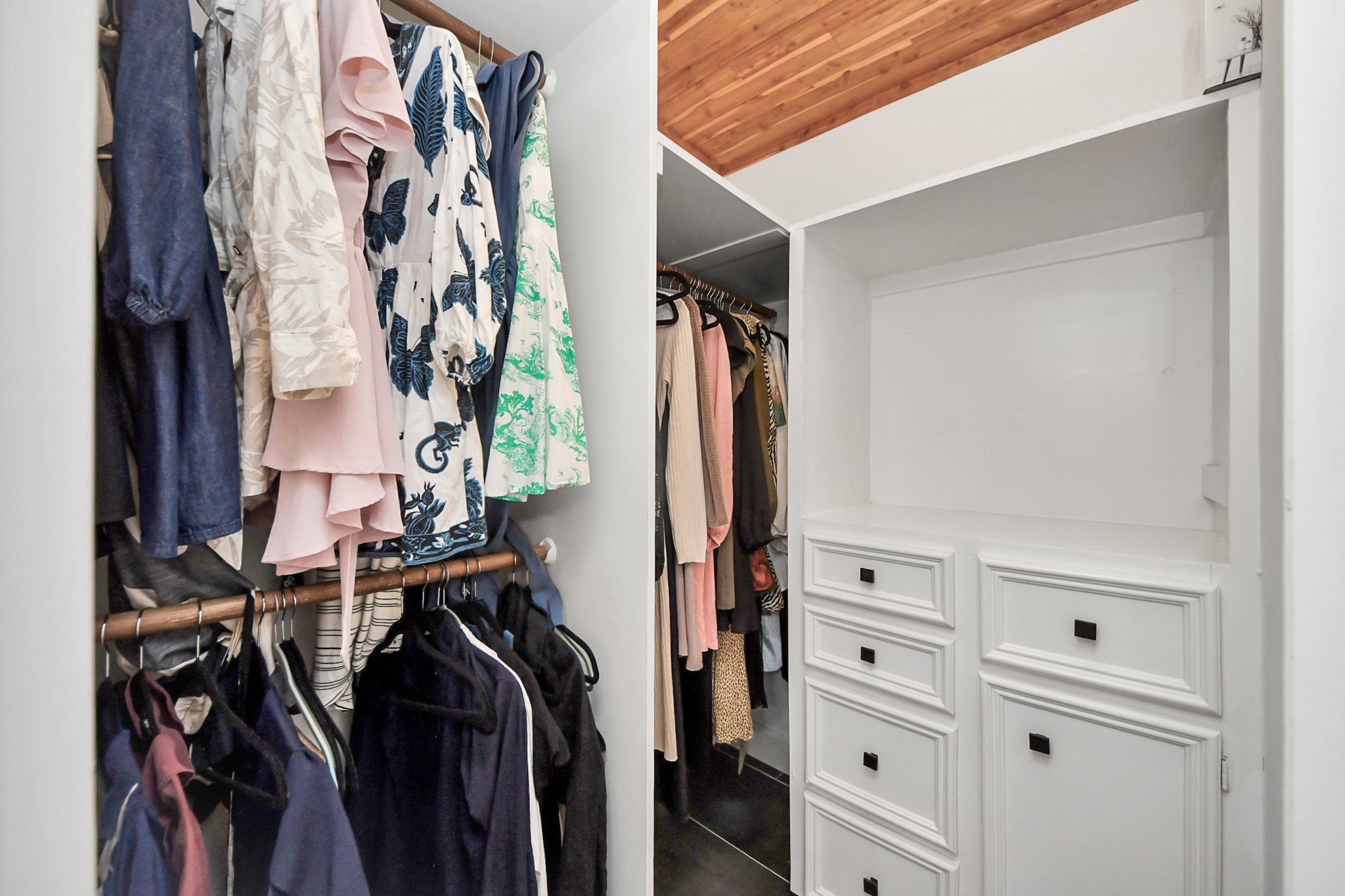 Spacious walk-in closet for her with ample storage.