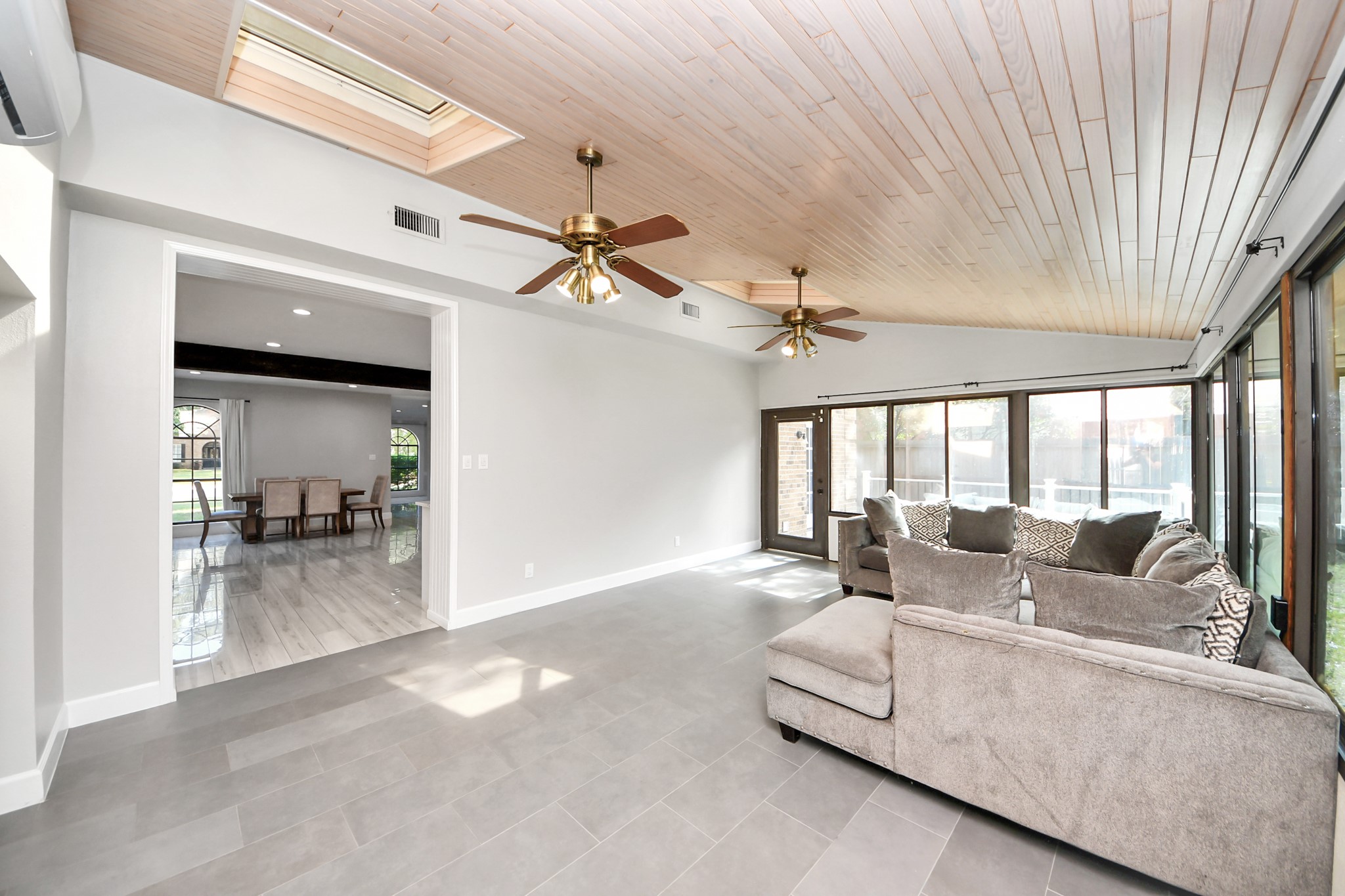 Experience the perfect blend of relaxation and entertainment in this sunlit game room, featuring skylights and a dedicated ductless mini-split for optimal comfort, seamlessly connected to the kitchen.