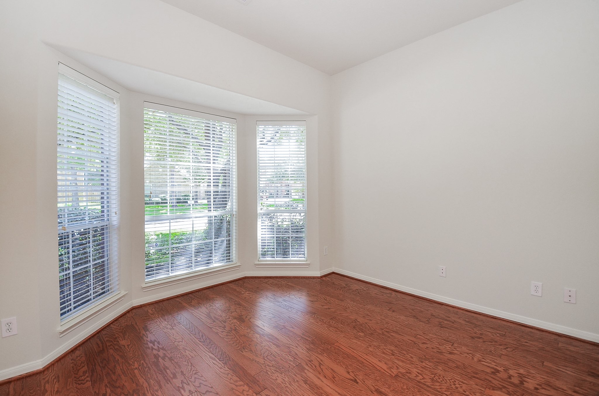 Stunning wood floors, and expansive windows create the ideal study or office space for both productivity and relaxation.