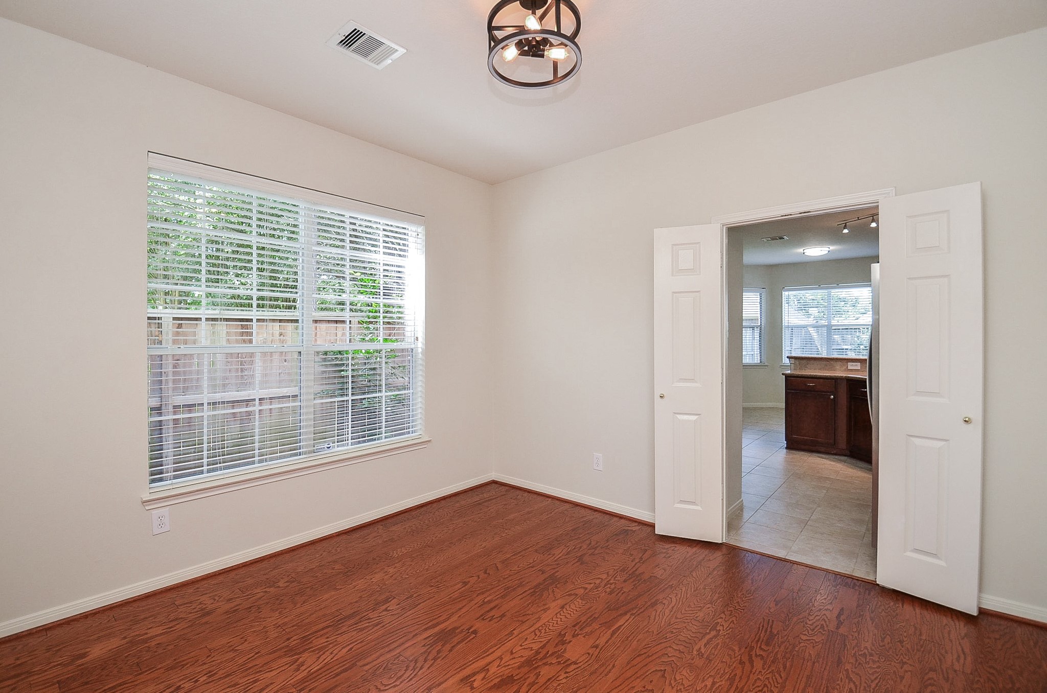 Bright and inviting, this dining room offers an abundance of natural light through large windows, creating the perfect setting for memorable gatherings.