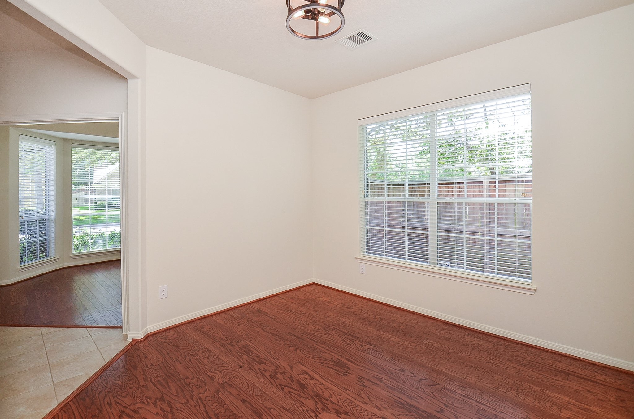 Bright and inviting, this dining room offers an abundance of natural light through large windows, creating the perfect setting for memorable gatherings.