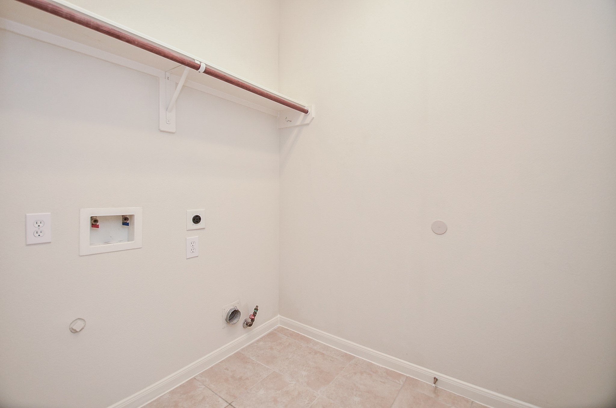 Nestled among lush greenery, this charming brick home offers convenience with an efficient in-house laundry room, perfect for modern living.