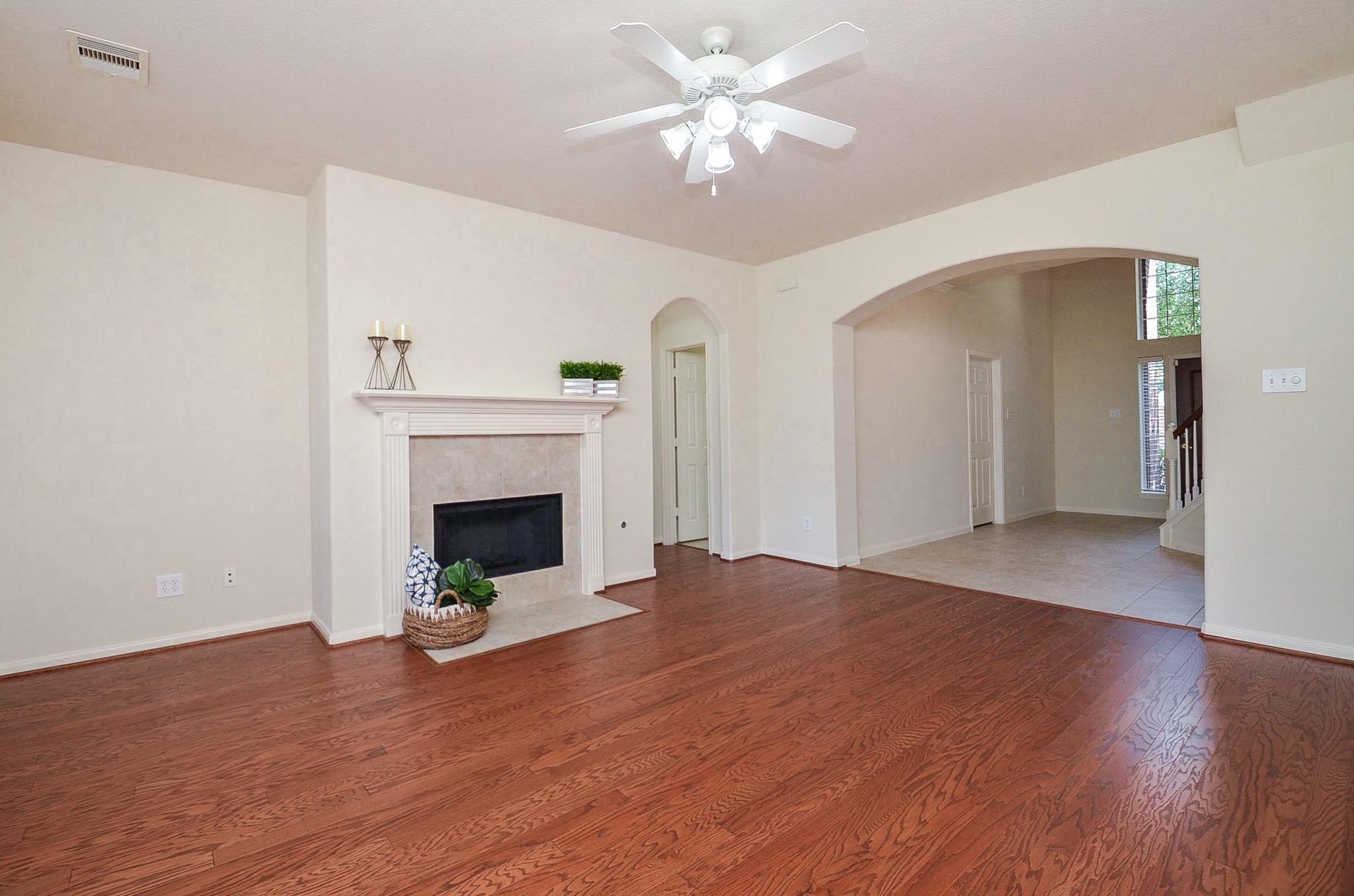 Inviting family room with warm wood flooring and abundant natural light, ideal for creating memories.