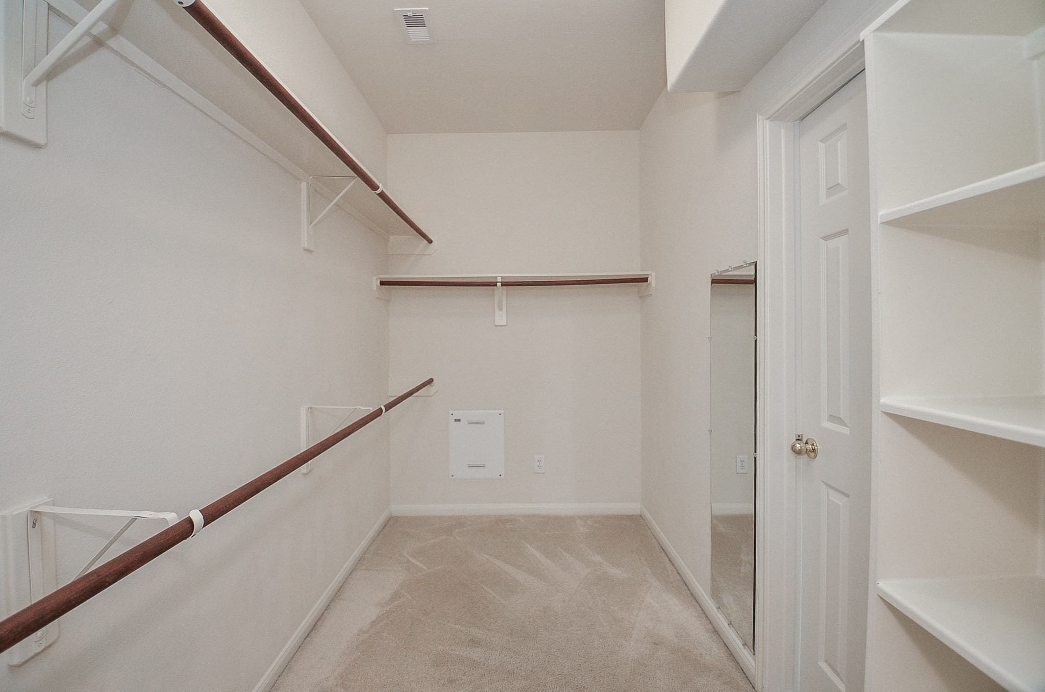Discover the ultimate in organization with this spacious walk-in closet, featuring ample shelving and hanging space to effortlessly accommodate your wardrobe.