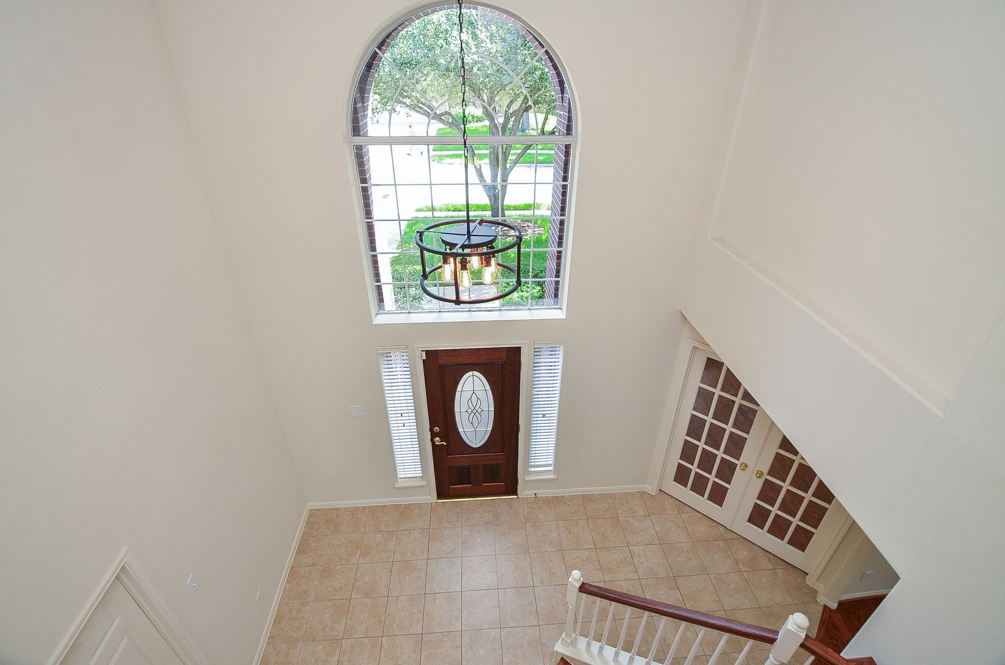 Step into elegance with an airy entryway, highlighted by soaring high ceilings.
