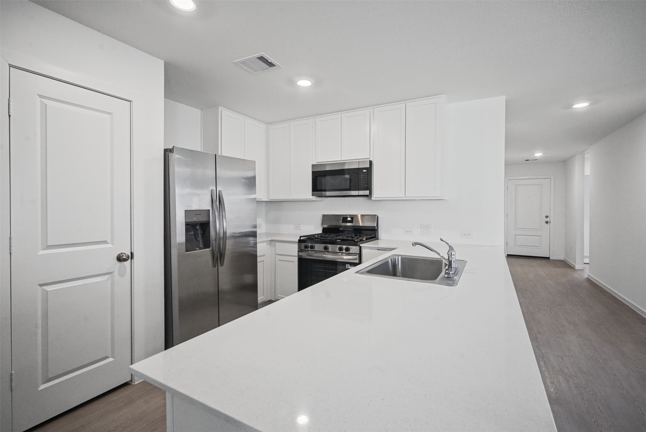 A kitchen made for more than just cooking, the oversized peninsula creates a natural hub for morning coffee, casual meals, and catching up at the end of the day.