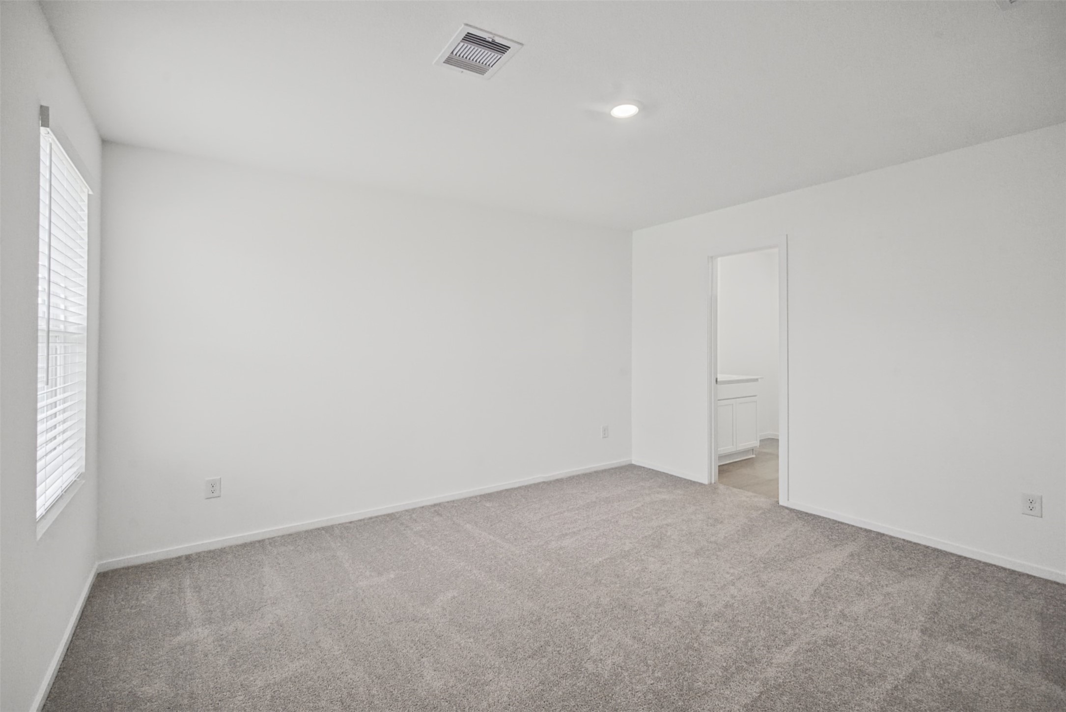 A spacious retreat ready to make your own, with plenty of room to create a comfortable sleeping area while maintaining an open, uncluttered feel.