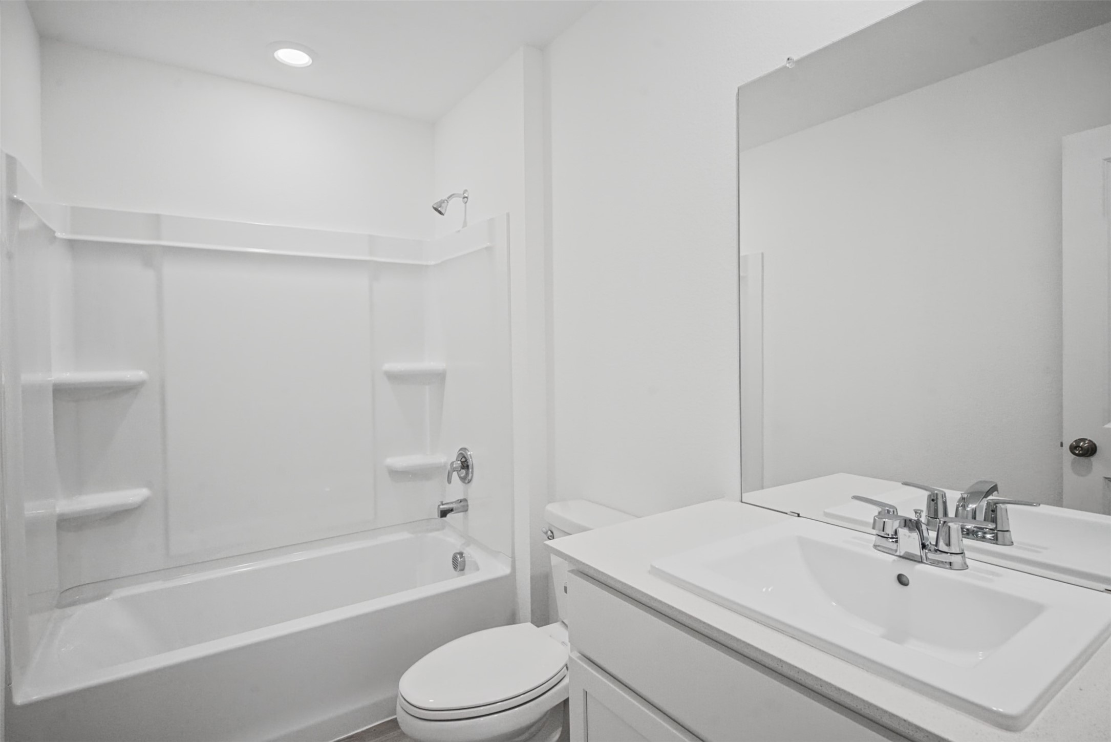 Designed for easy everyday routines, this fresh full bath combines a spacious vanity with a tub-and-shower setup for added versatility.