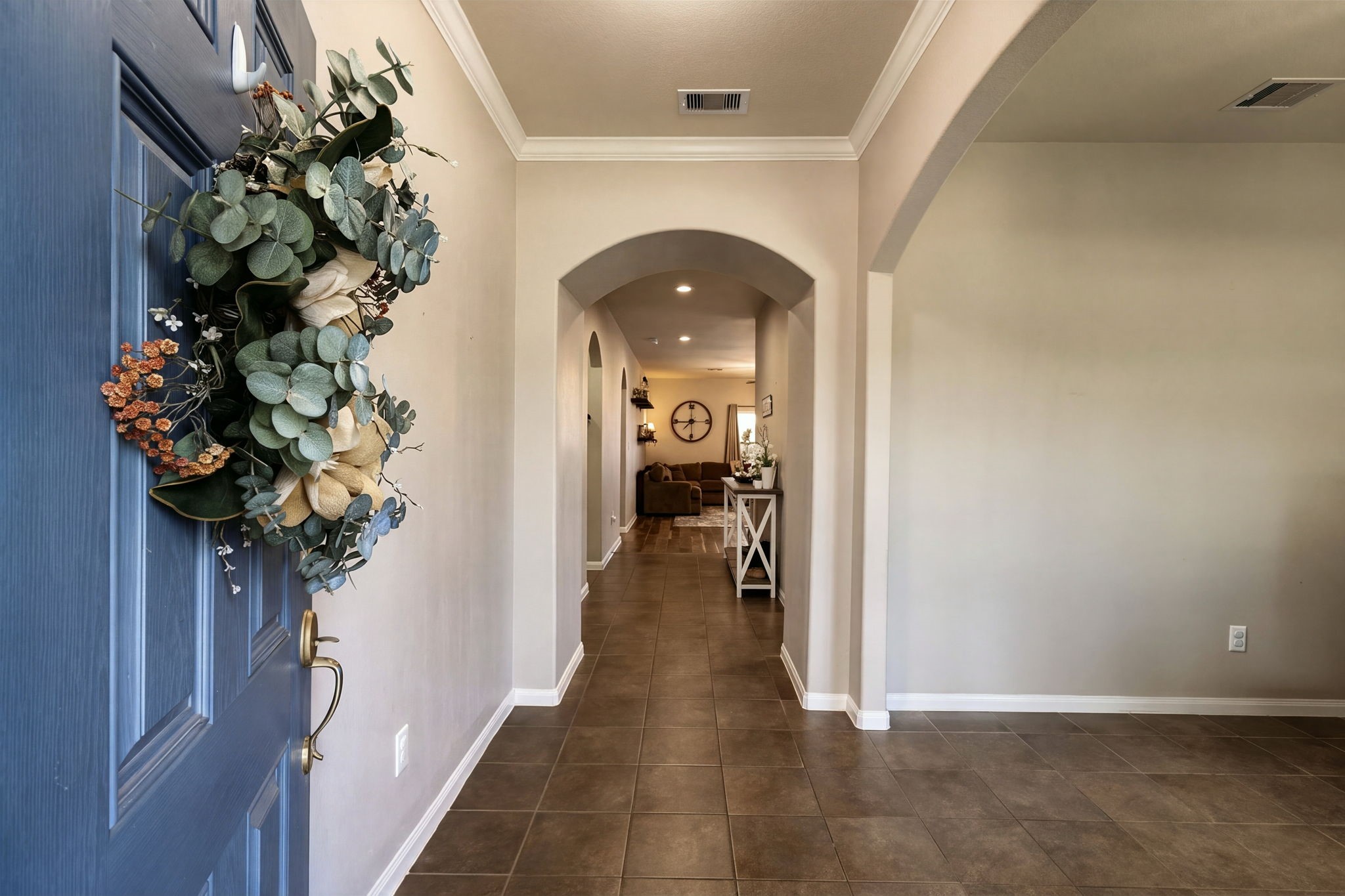 Charming entryway leading to a spacious hallway with elegant archways and tiled flooring. Charming entryway leading to a spacious hallway with elegant archways and tiled flooring.