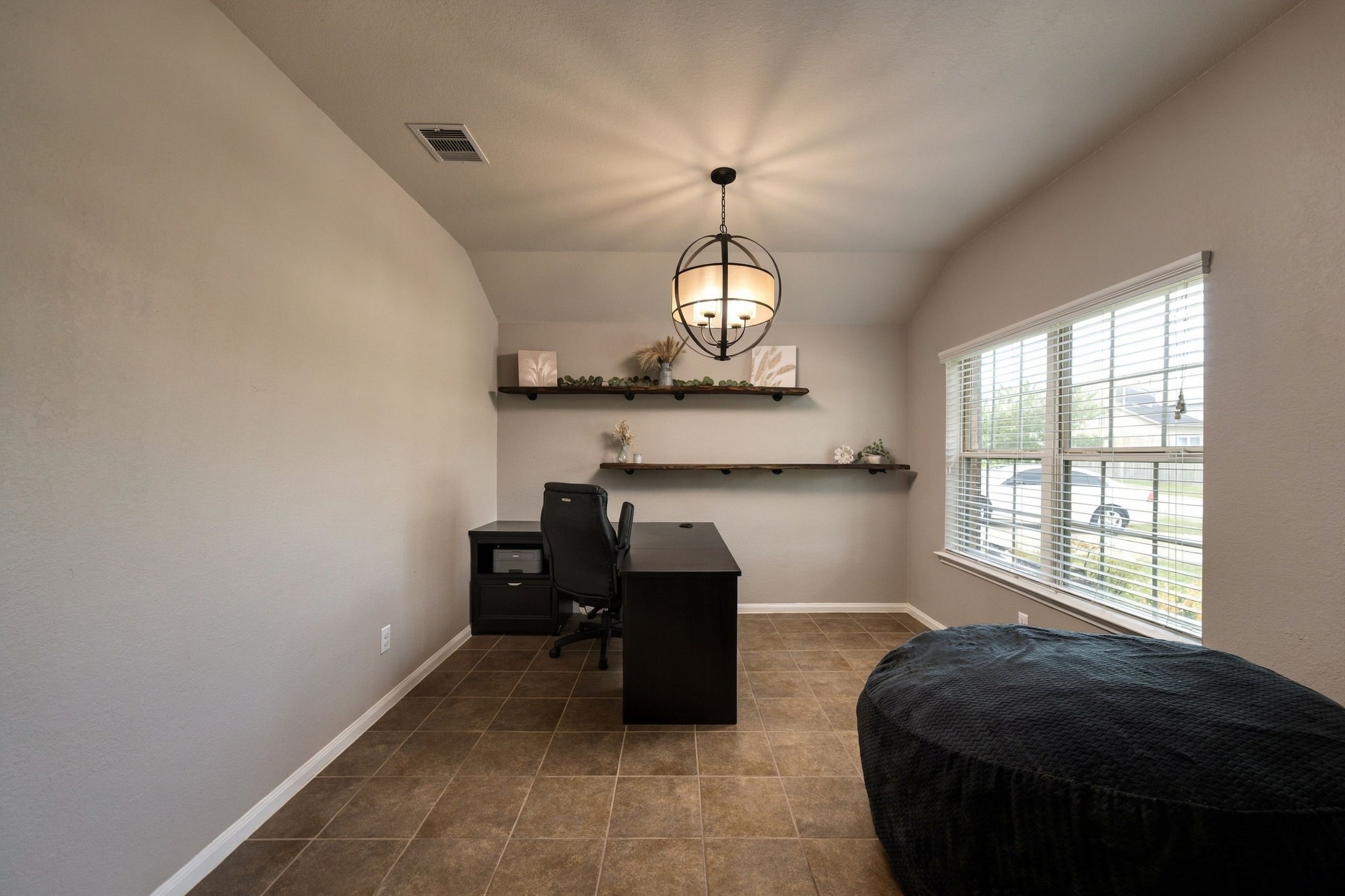 Spacious home office with a modern lighting, with large windows providing ample natural light.