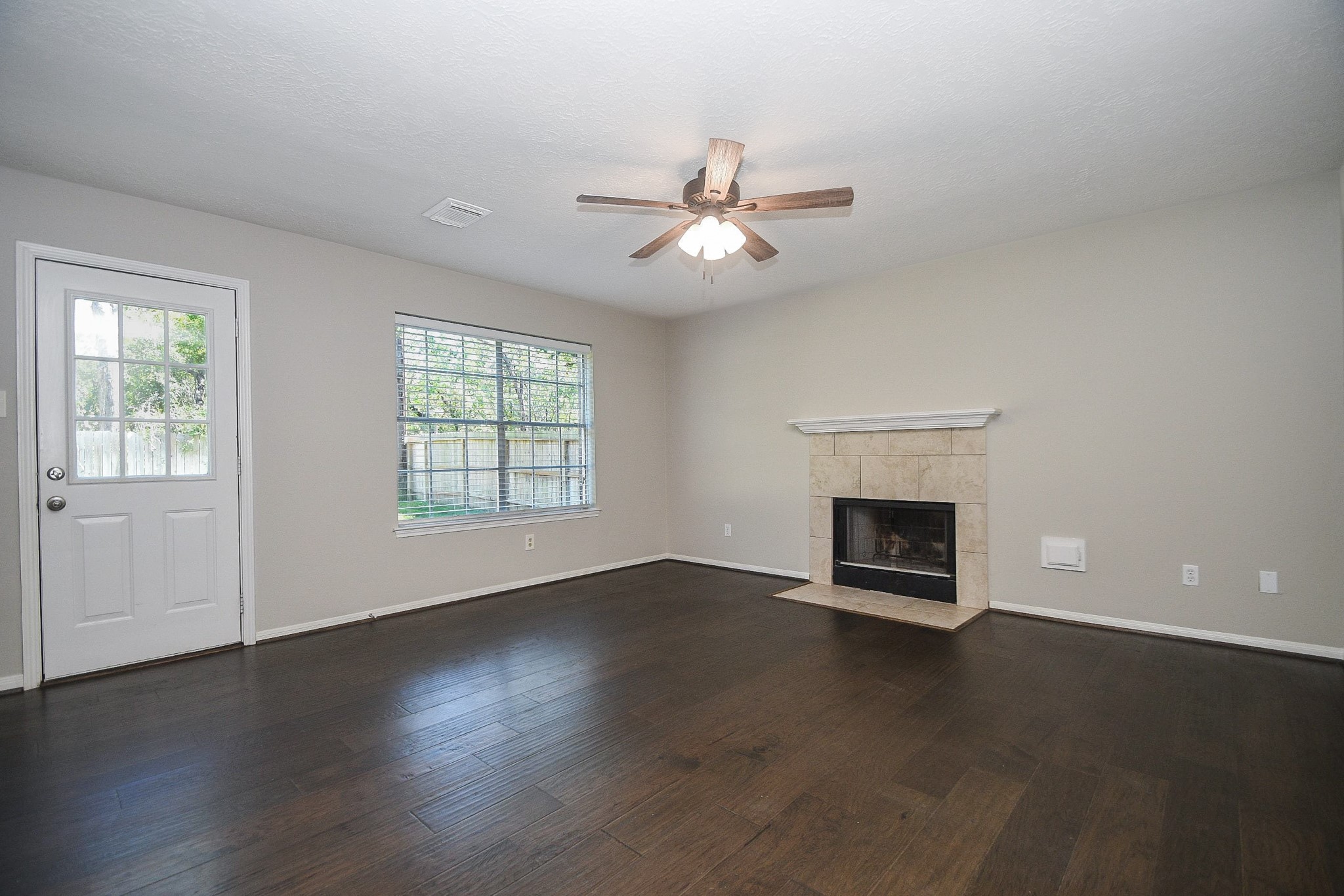 This large family room has a fireplace which is hard to find in new builds.