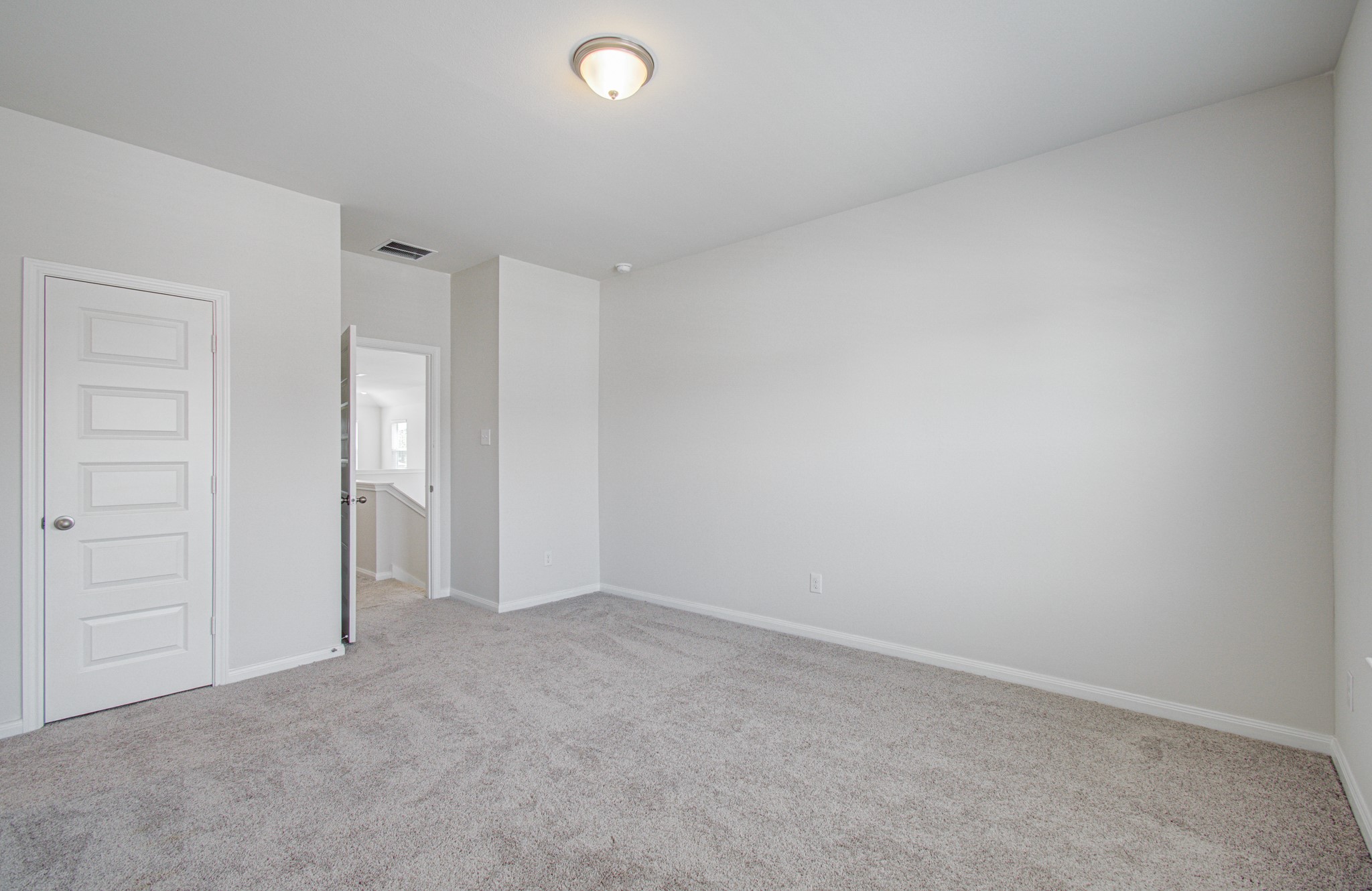 Spacious, bright room with plush carpeting and neutral walls, offering a versatile blank canvas for your personal touch. Please Note this is a different home/floorplan in the community.